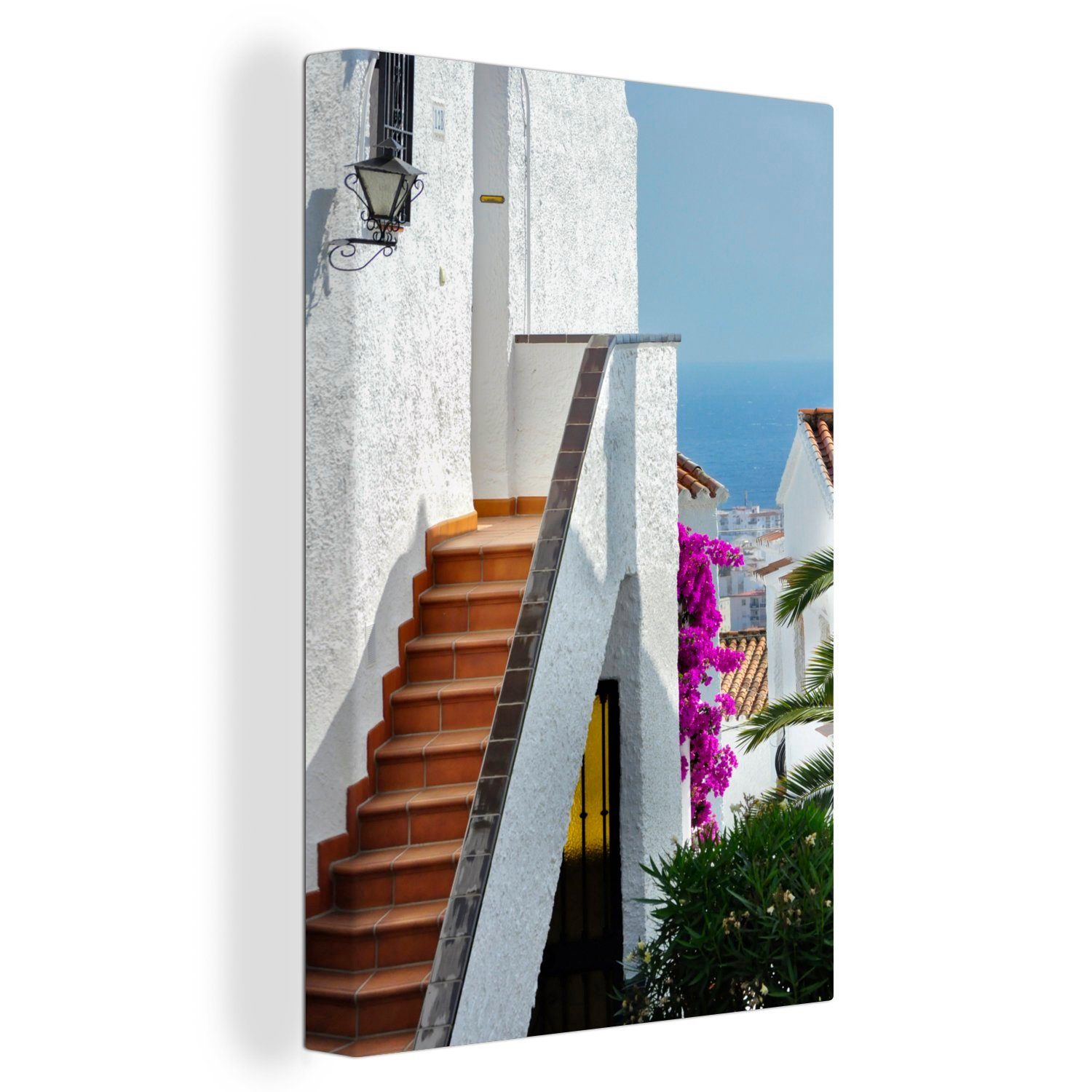 OneMillionCanvasses® Leinwandbild Ein Blick St), zwischen weißen Gemälde, den auf 20x30 cm Leinwandbild Häusern Meer (1 bespannt Spaniens, Zackenaufhänger, fertig das inkl