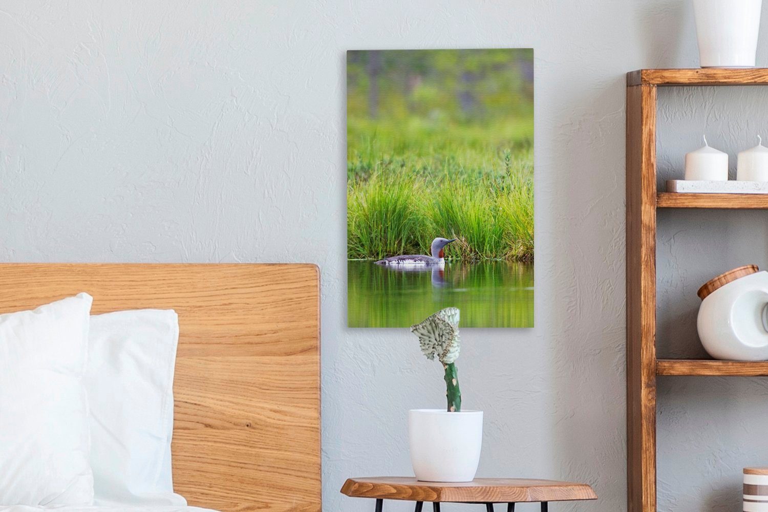 OneMillionCanvasses® Leinwandbild Rotkehltaucher schwimmt Gemälde, bespannt Zackenaufhänger, vor inkl. Leinwandbild fertig grünen Landschaft, (1 St), einer cm 20x30