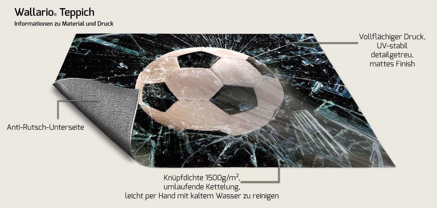Wallario Teppich Fußball - im Fenster, Splitter und Glas, rechteckig, rutschfest