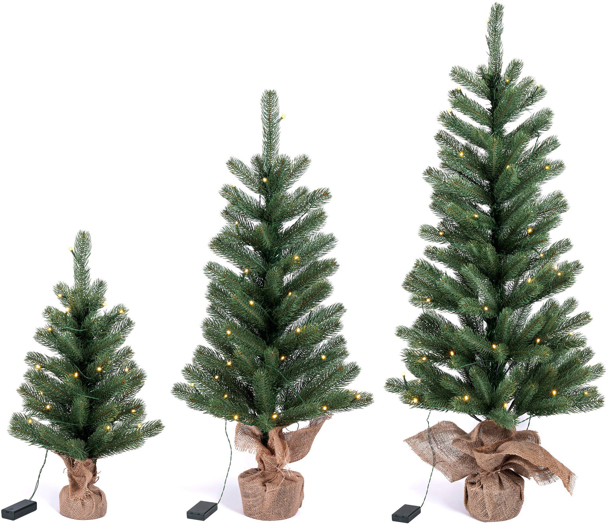 den 60 Höhe künstlicher Winterworld Jutebeutel Batteriebetrieb Künstlicher cm, Weihnachtsbaum mit Weihnachtsdeko LED-Tannenbaum, ca. Betonfuß, IC um Christbaum, Nordmanntanne,