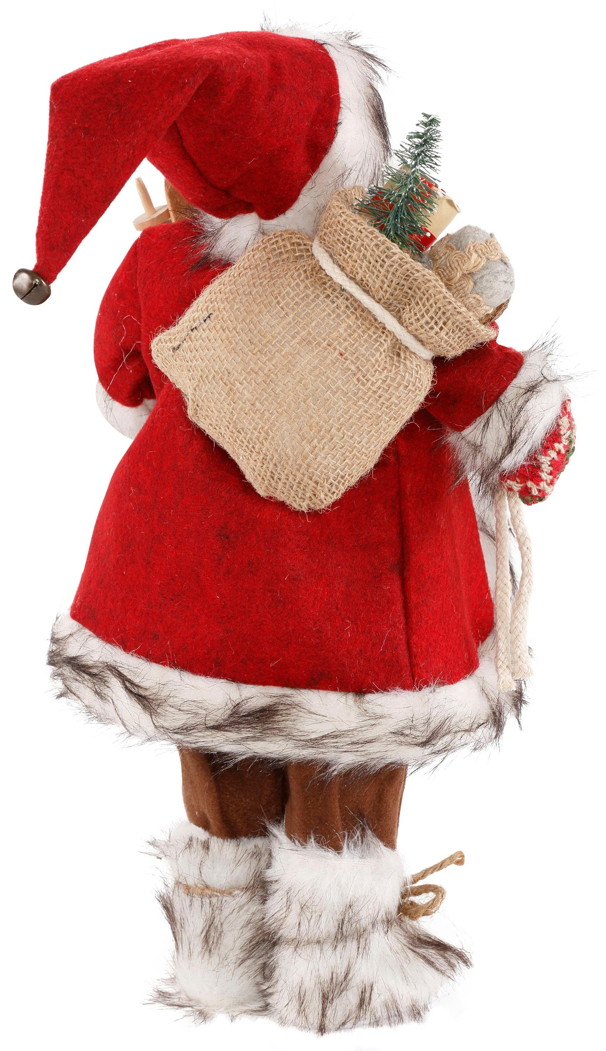 HOSSNER - HOMECOLLECTION Weihnachtsmann Santa Geschenken Dekofigur, und dem (1 mit St), Weihnachtsfigur Skiern Arm unter Weihnachtsdeko