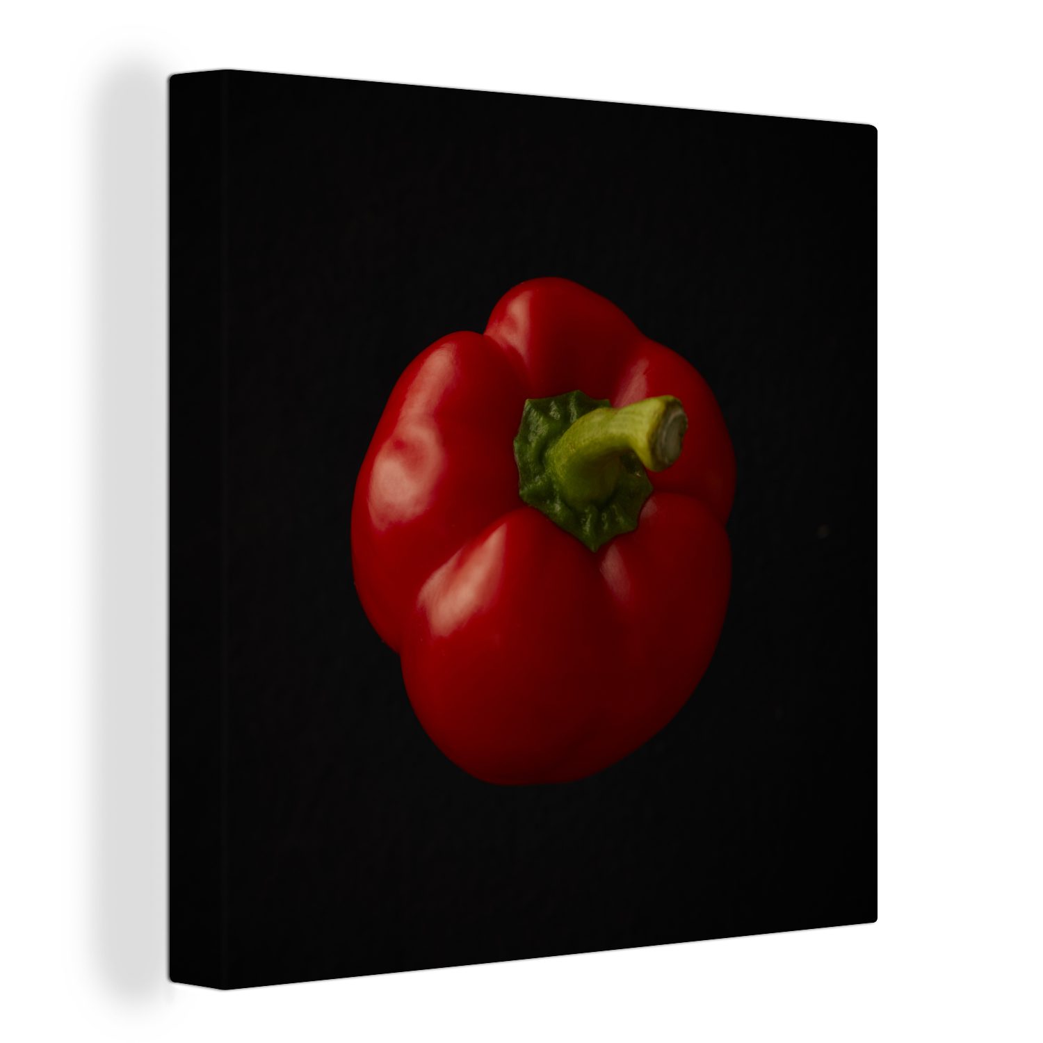 OneMillionCanvasses® Leinwandbild Eine rote Paprika auf schwarzem Hintergrund, (1 St), Leinwand Bilder für Wohnzimmer Schlafzimmer