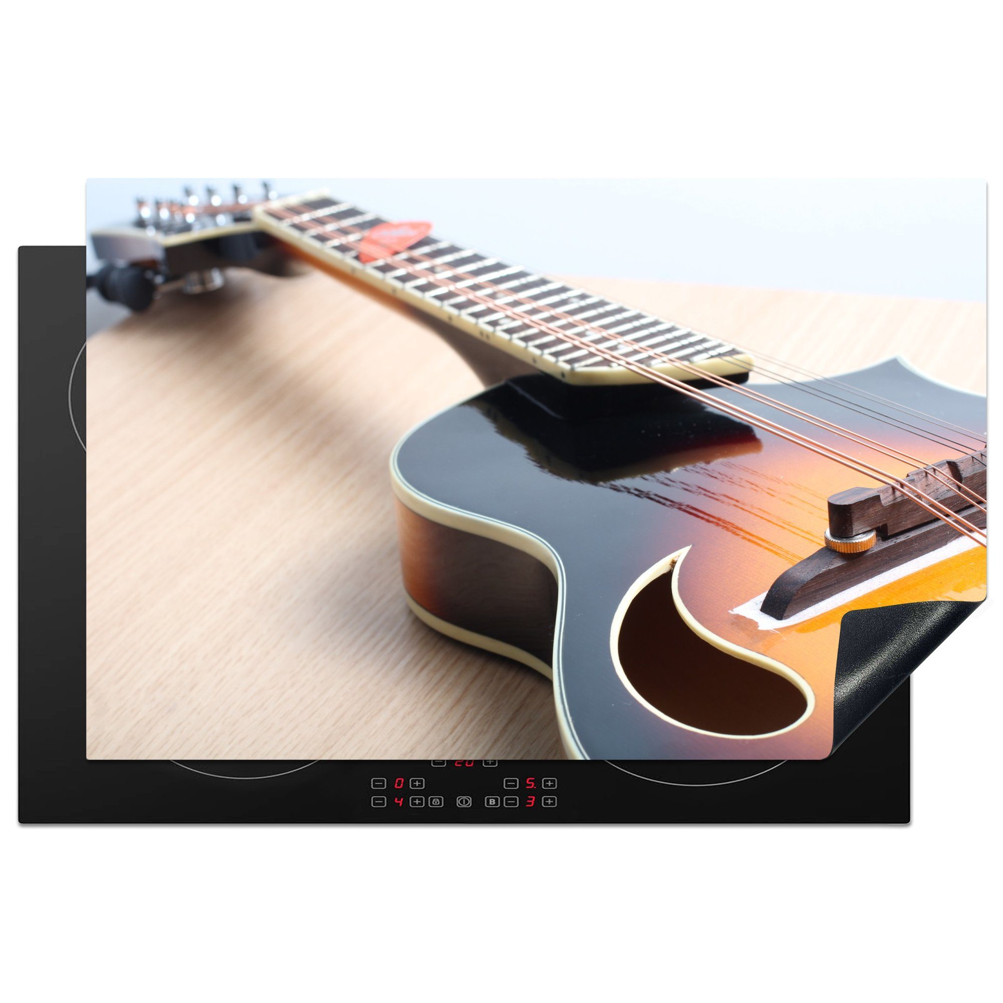 MuchoWow Herdblende-/Abdeckplatte Eine E-Gitarre auf einem Holzboden, Vinyl, (1 tlg), 81x52 cm, Induktionskochfeld Schutz für die küche, Ceranfeldabdeckung