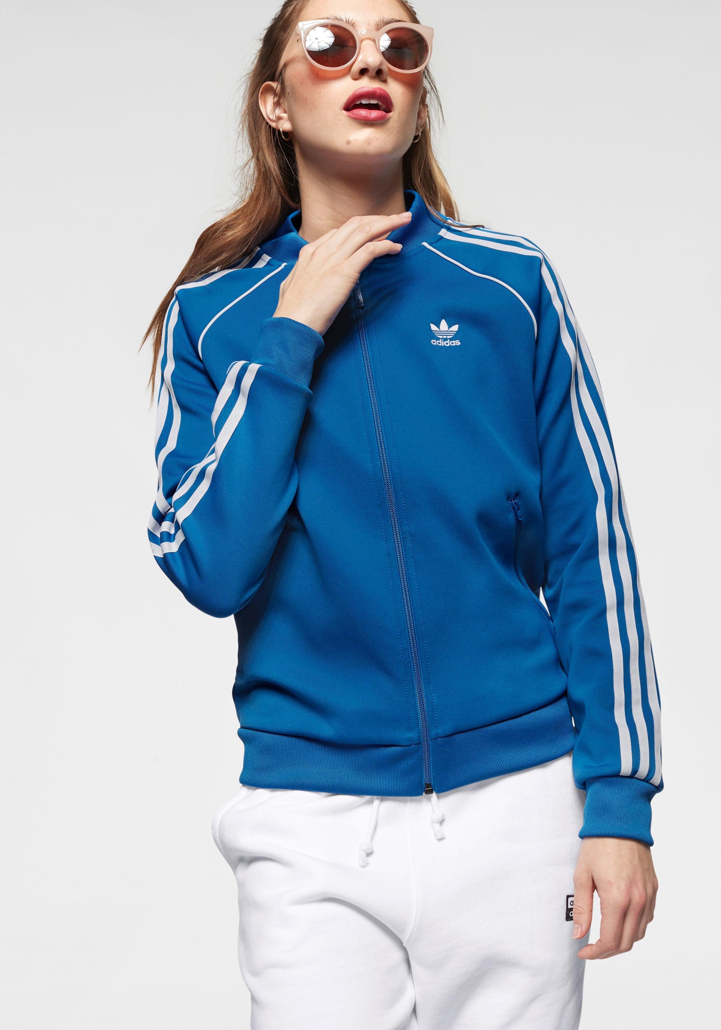Adidas Joggingjacke hellblau glänzend mit weißen Streifen Adidas Joggingjacke hellblau glänzend mit weißen Streifen