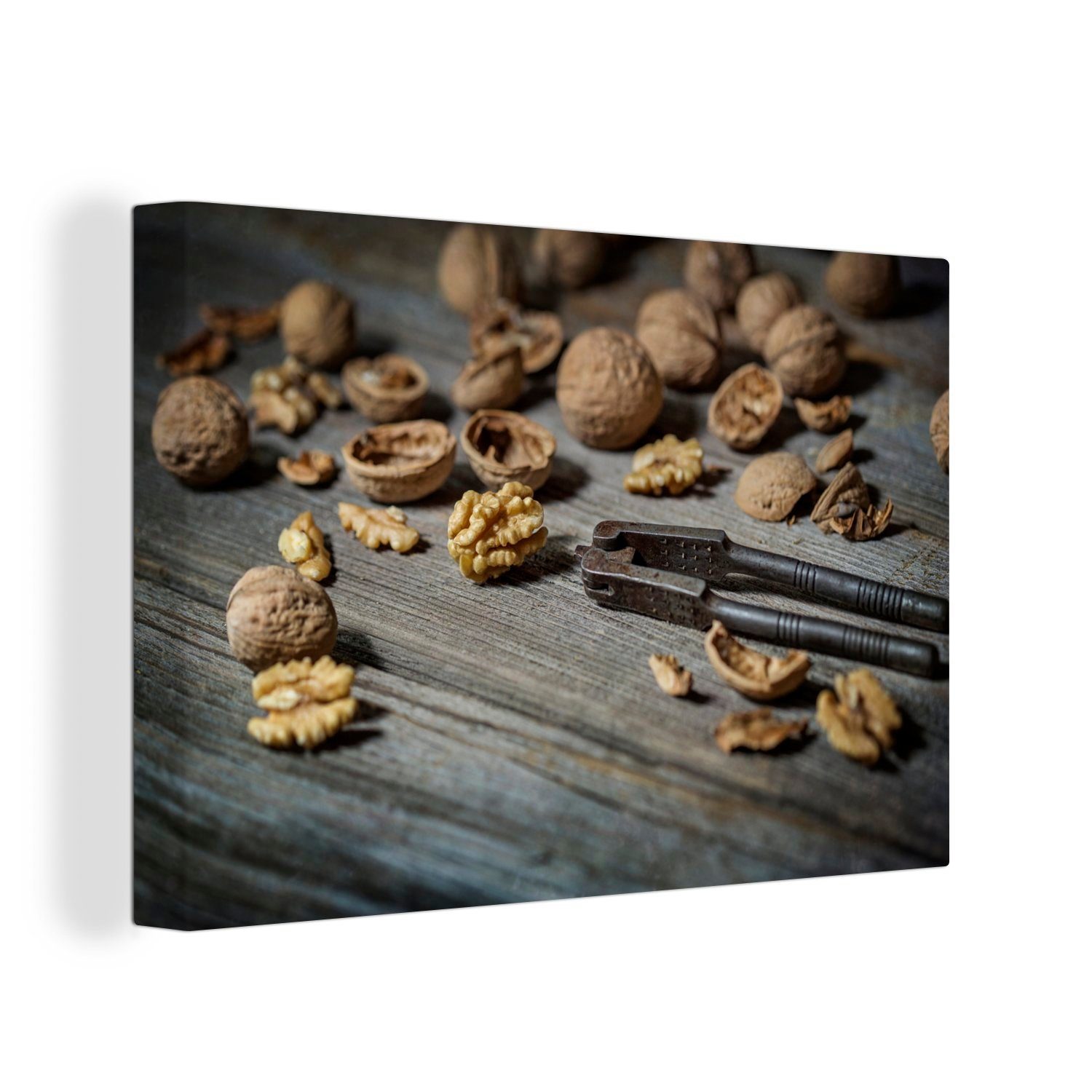 OneMillionCanvasses® Leinwandbild Geknackte Nüsse auf einem dunklen Holztisch, (1 St), Wandbild Leinwandbilder, Aufhängefertig, Wanddeko, 30x20 cm
