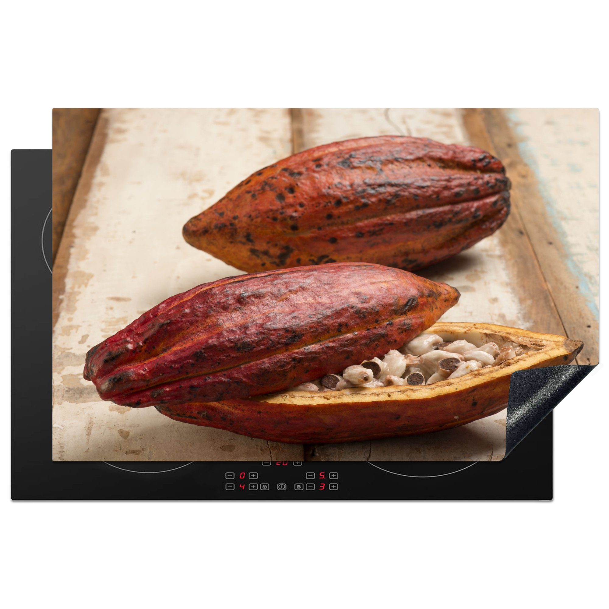 MuchoWow Herdblende-/Abdeckplatte Tropische Kakaobohnenschote auf einem Holztisch, Vinyl, (1 tlg), 81x52 cm, Induktionskochfeld Schutz für die küche, Ceranfeldabdeckung