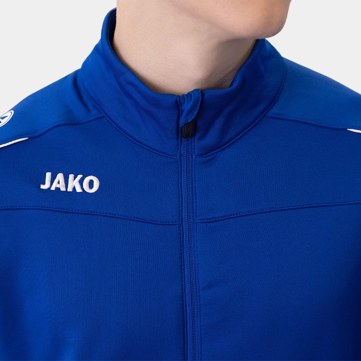 Jako Sportanzug mit Reißverschluss Sportjacke mit Seitentaschen für Unisex, Normal Fit Rundhals unifarben atmungsaktiv Reißverschluss