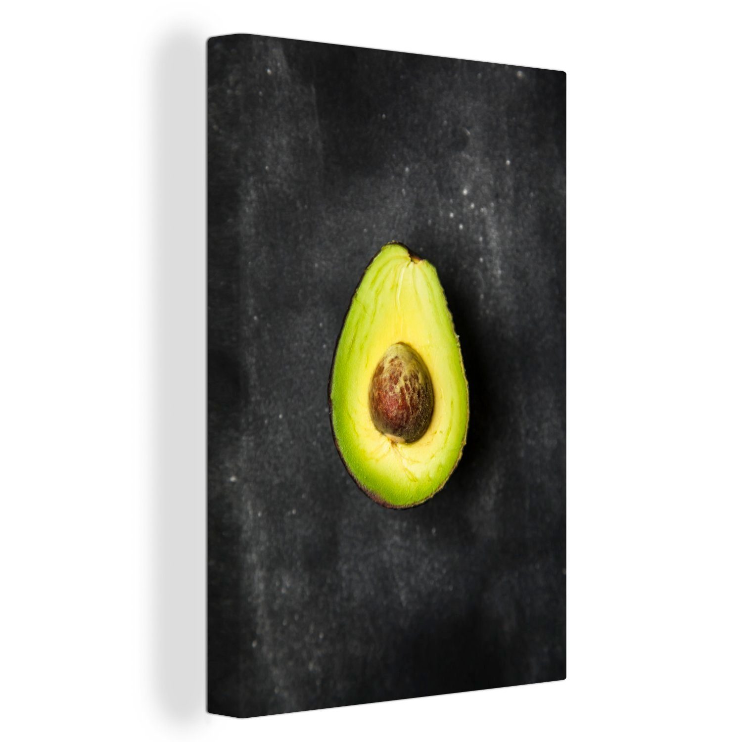 OneMillionCanvasses® Leinwandbild Einsame Avocado auf einem schwarzen Tisch, (1 St), Leinwandbild fertig bespannt inkl. Zackenaufhänger, Gemälde, 20x30 cm