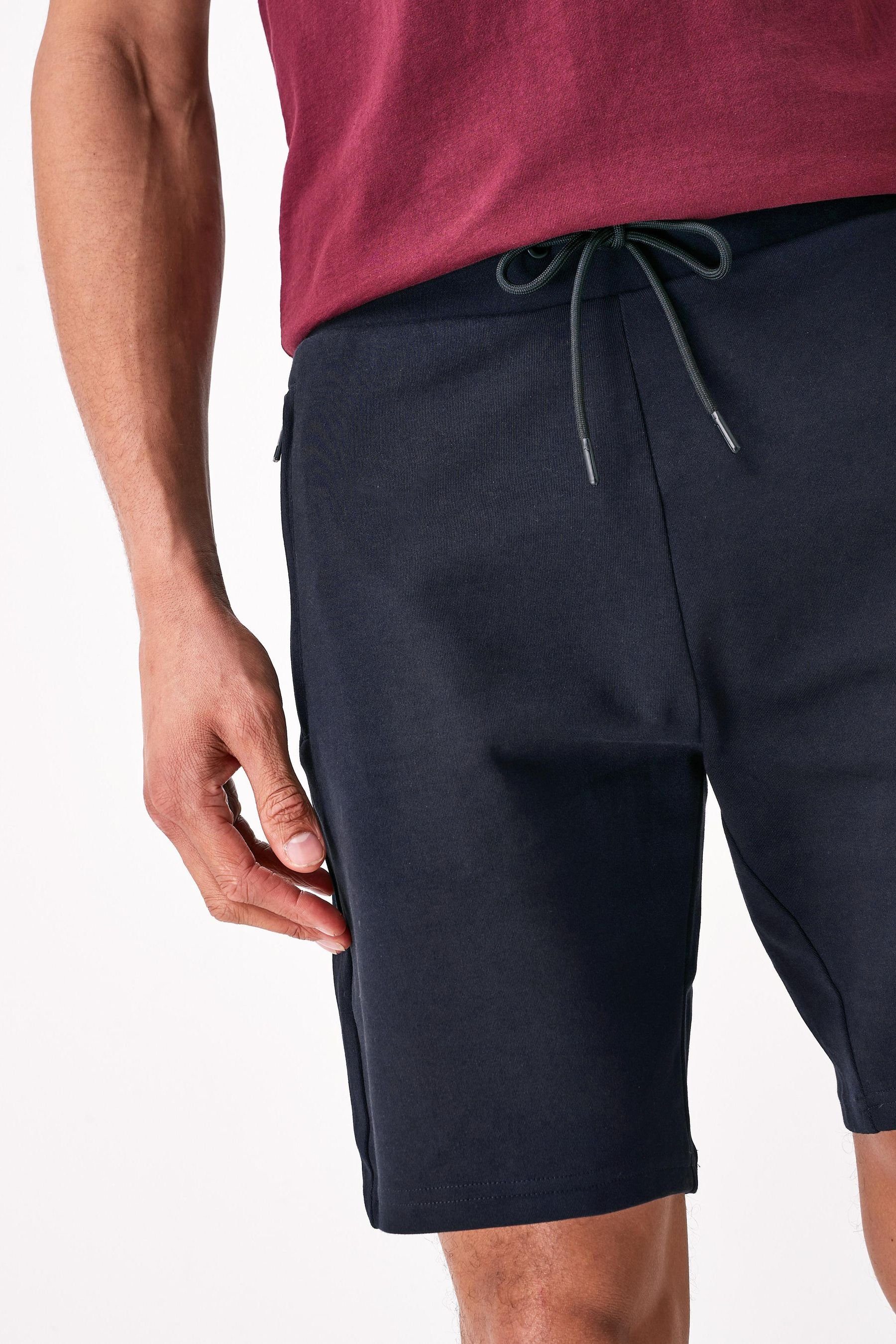 Jersey-Shorts Fit mit Navy Reißverschlusstaschen-Slim (1-tlg) Blue Sweatshorts Next