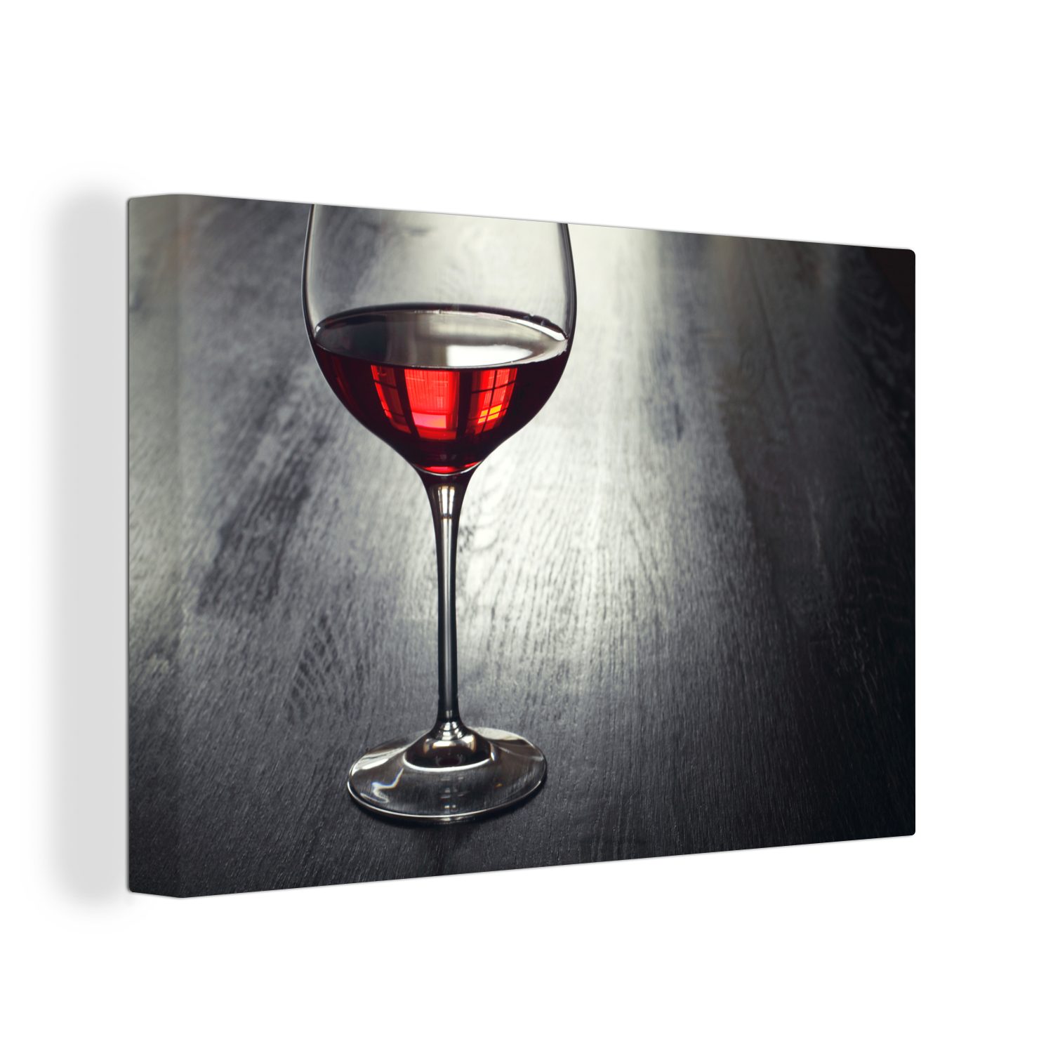 Leinwandbild Glas Rotwein auf einem Holzteller