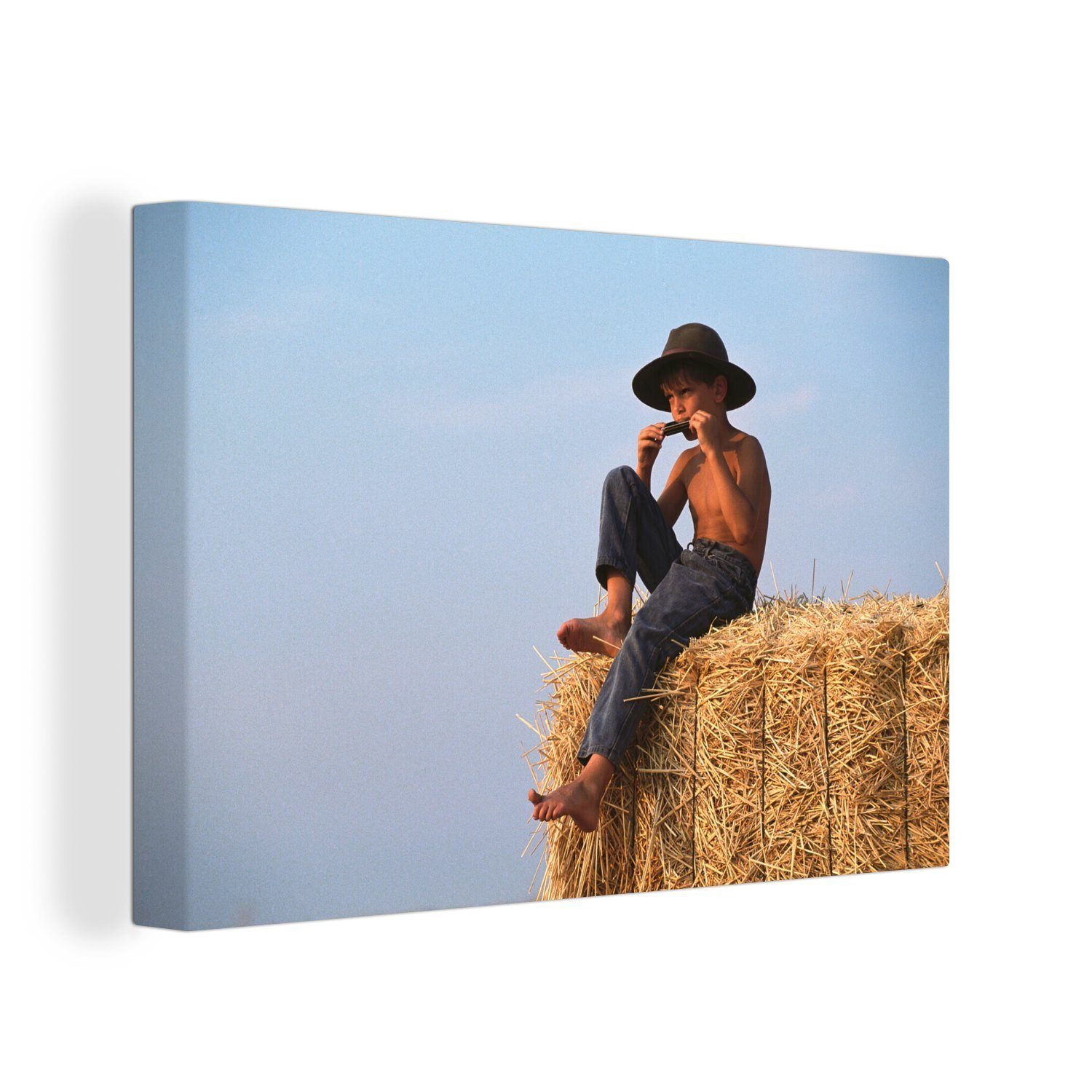 OneMillionCanvasses® Leinwandbild Junge spielt die Mundharmonika, (1 St), Wandbild Leinwandbilder, Aufhängefertig, Wanddeko, 30x20 cm