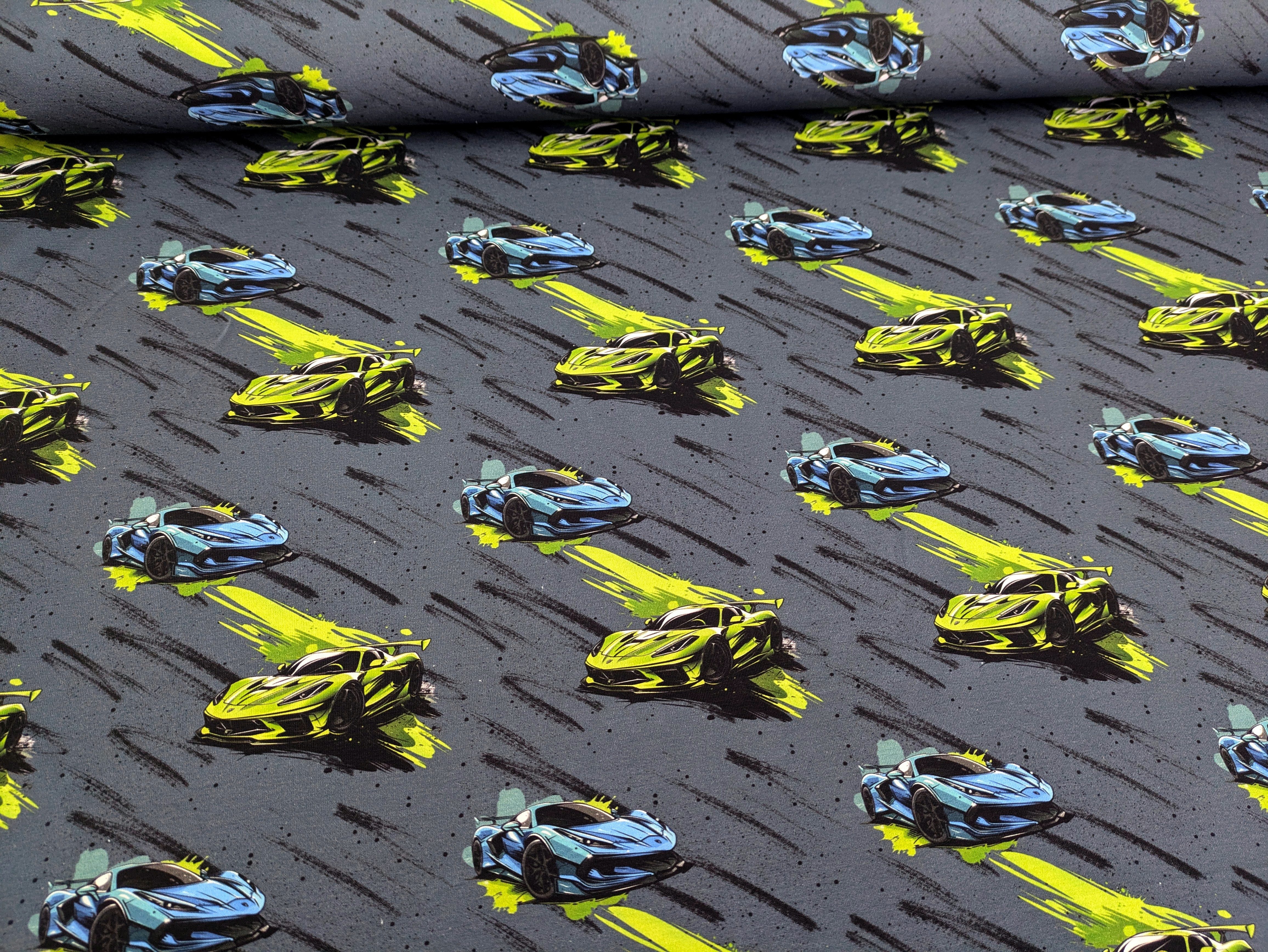 Thumbnail - Corileo Stoff Eigenproduktion Baumwolljersey Speed Autos auf Jeans Graublau
