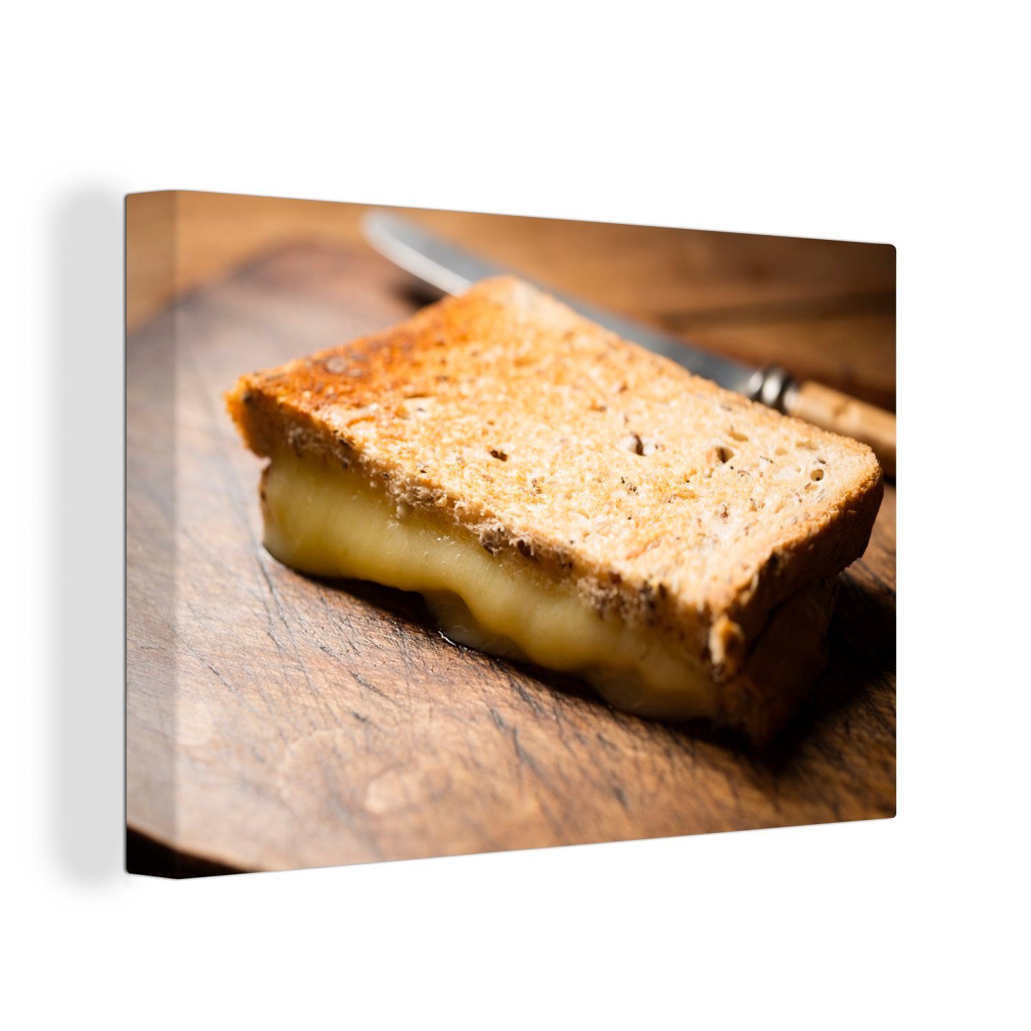 OneMillionCanvasses® Leinwandbild Toast mit geschmolzenem Käse auf einem Schneidebrett, (1 St), Wandbild Leinwandbilder, Aufhängefertig, Wanddeko, 30x20 cm