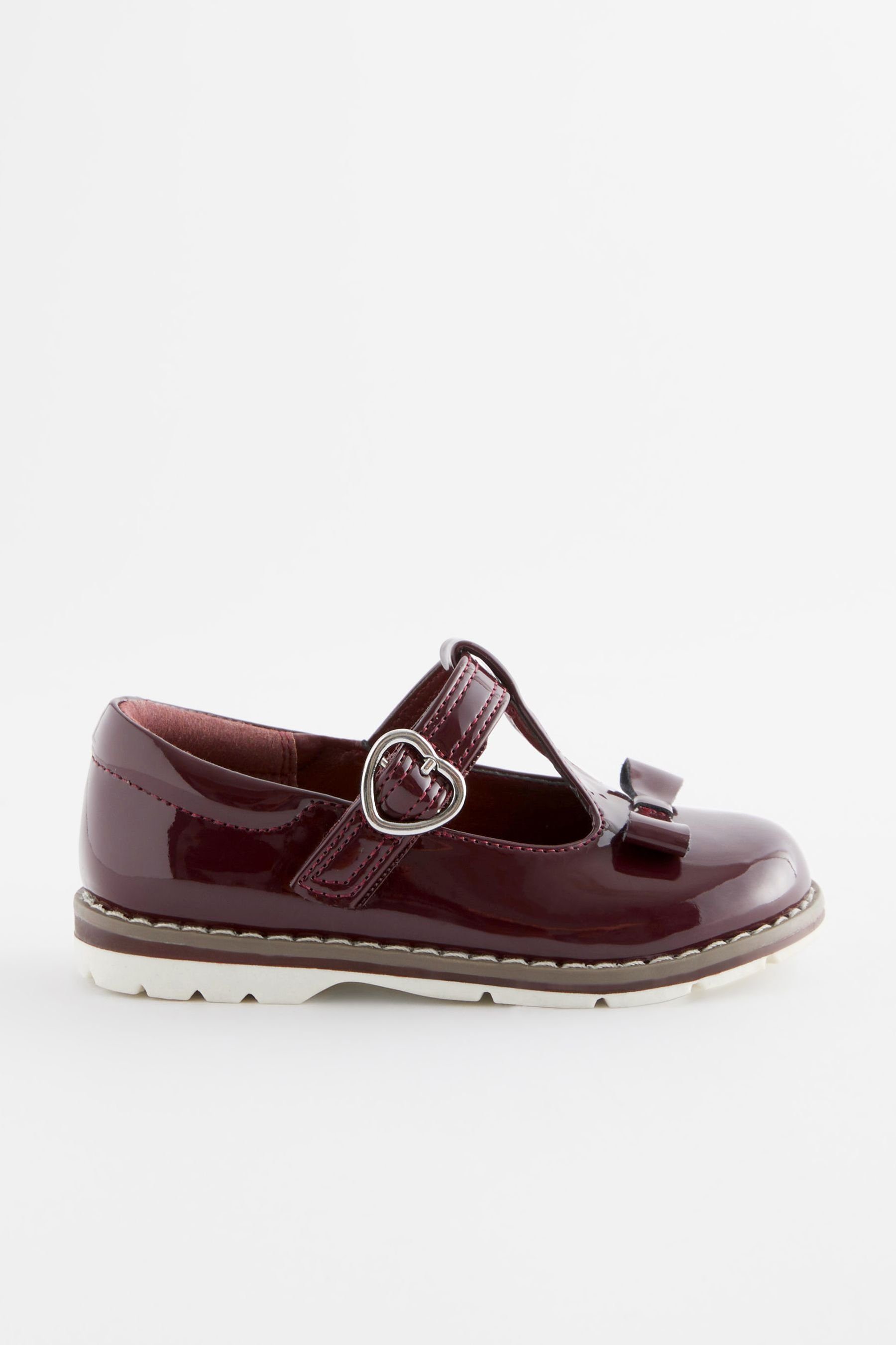 mit Next T-Steg Schuhe T-Strap-Sandale und Plum (1-tlg) Schleife, Purple Passform weite Patent