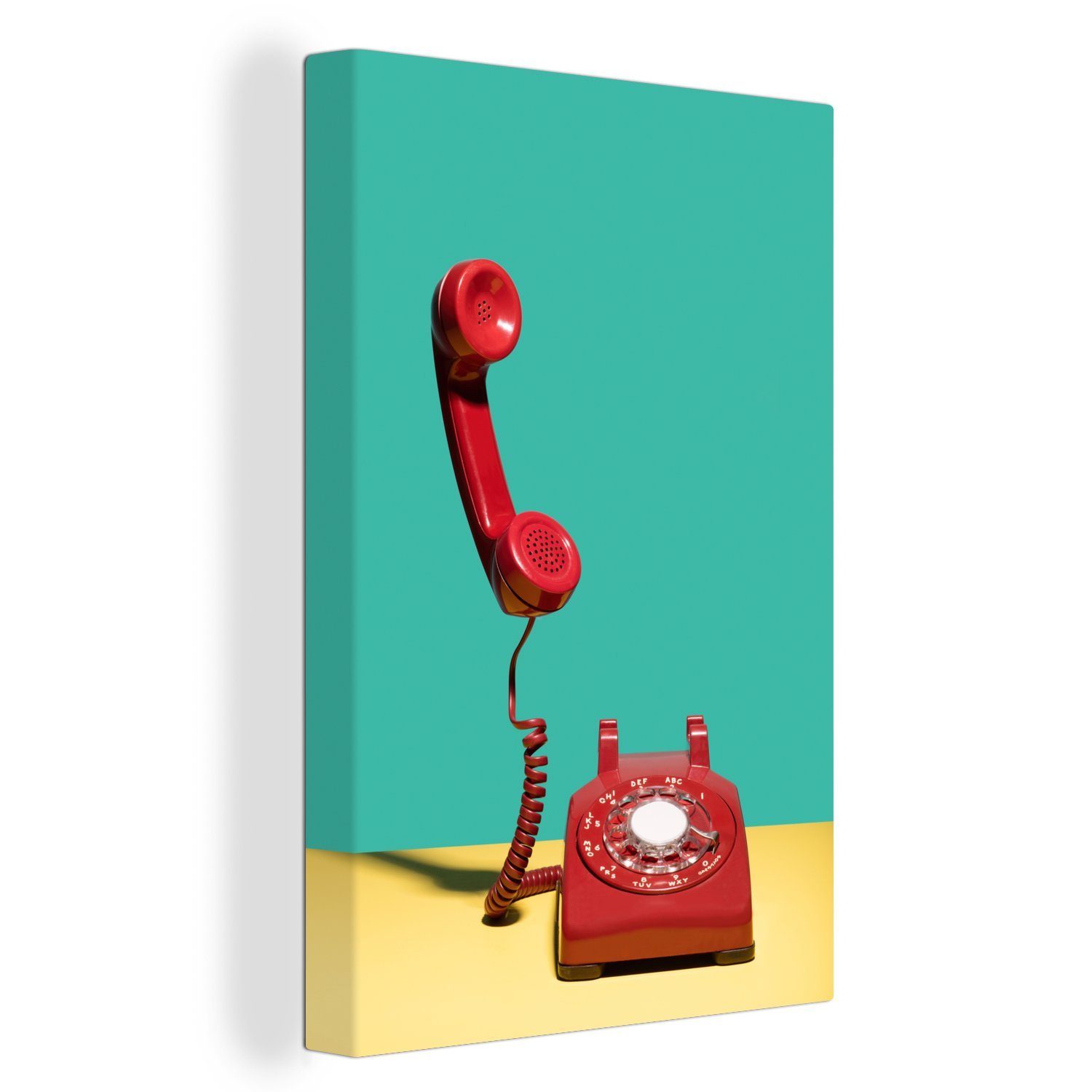 OneMillionCanvasses® Leinwandbild Ein rotes Retro-Telefon auf gelbem Hintergrund vor einer grünen Wand, (1 St), Leinwandbild fertig bespannt inkl. Zackenaufhänger, Gemälde, 20x30 cm