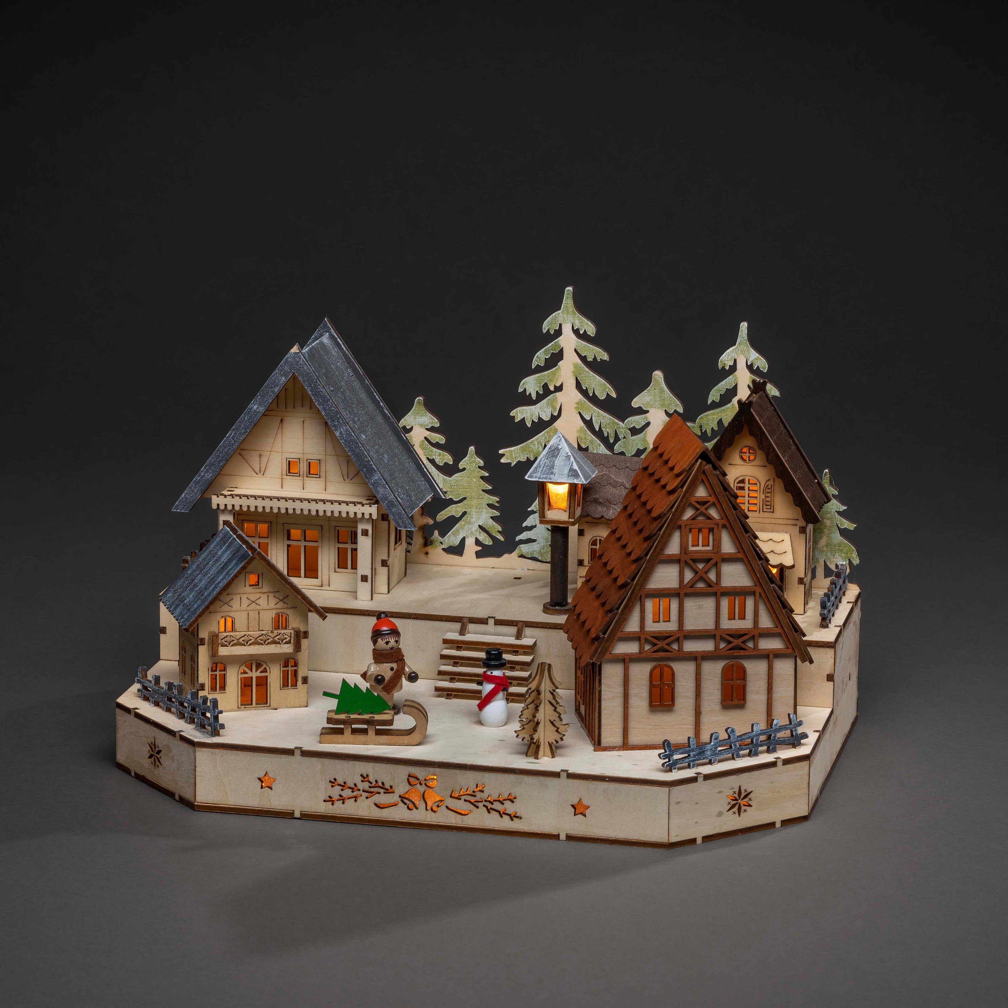 KONSTSMIDE Weihnachtsdorf Weihnachtsdeko, LED Holzsilhouette, Dorf mit Schneemann, Kind und Schlitten