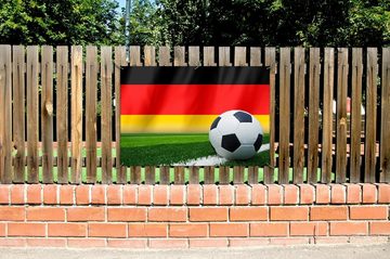 Wallario Sichtschutzzaunmatten Fußball vor einer Deutschlandflagge