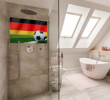 Wallario Wandfolie, Fußball vor einer Deutschlandflagge, wasserresistent, geeignet für Bad und Dusche