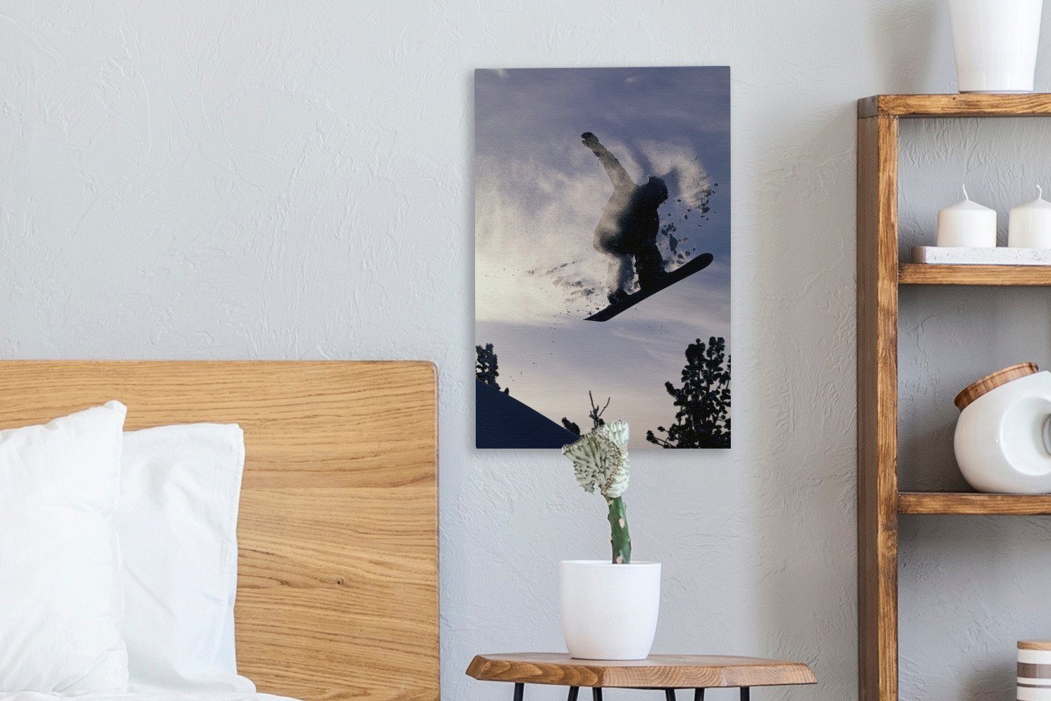 OneMillionCanvasses® Leinwandbild Ein Snowboarder hängt bespannt fertig Gemälde, Schnee cm Leinwandbild inkl. Zackenaufhänger, den in 20x30 der Luft (1 St), und mit, nimmt