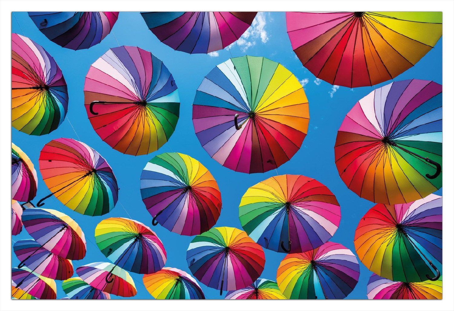 Wallario Wandfolie, Bunte Regenschirme vor blauem Himmel, in verschiedenen Ausführungen