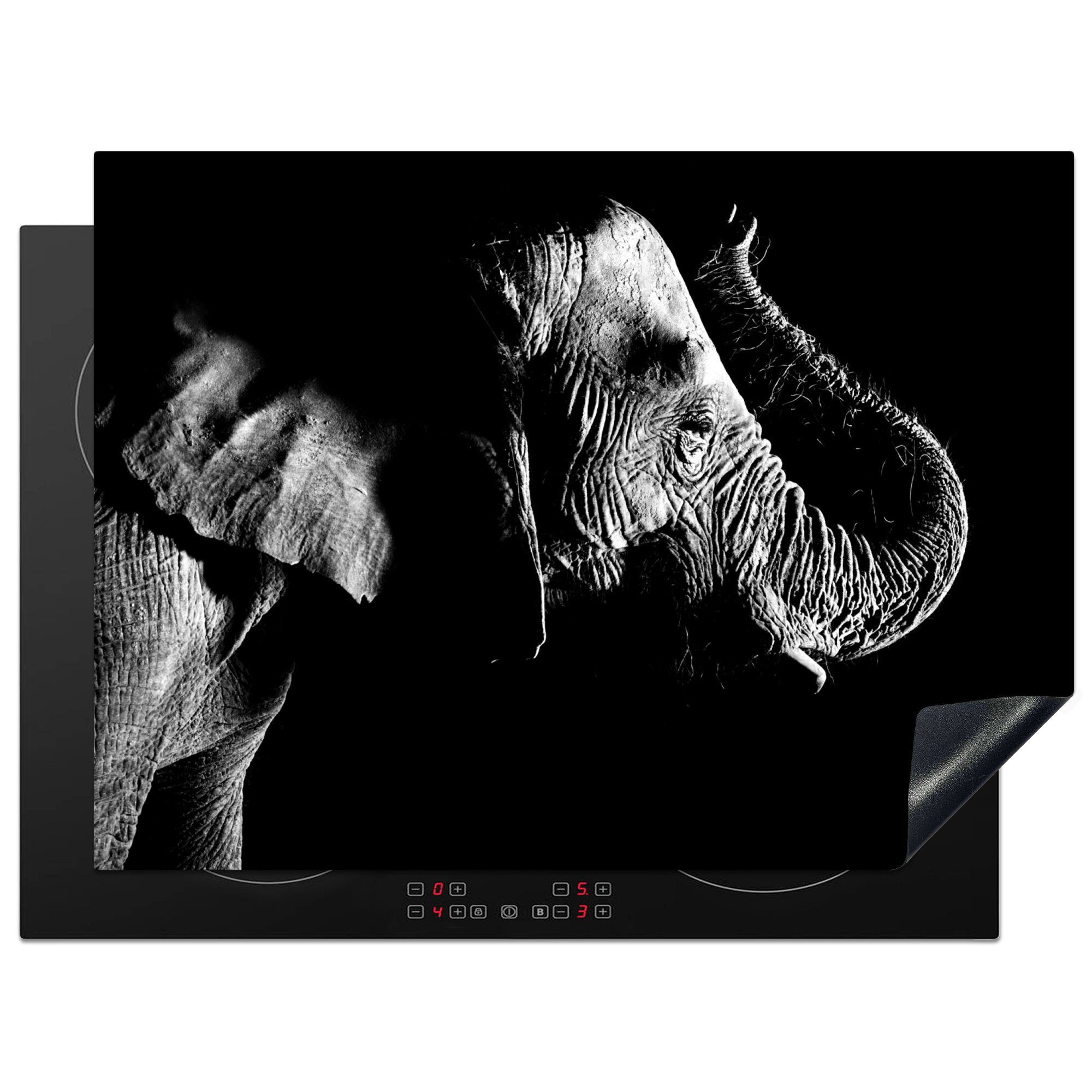 MuchoWow Herdblende-/Abdeckplatte Elefant mit erhobenem Rüssel auf schwarzem Hintergrund - schwarz-weiß, Vinyl, (1 tlg), 70x52 cm, Mobile Arbeitsfläche nutzbar, Ceranfeldabdeckung