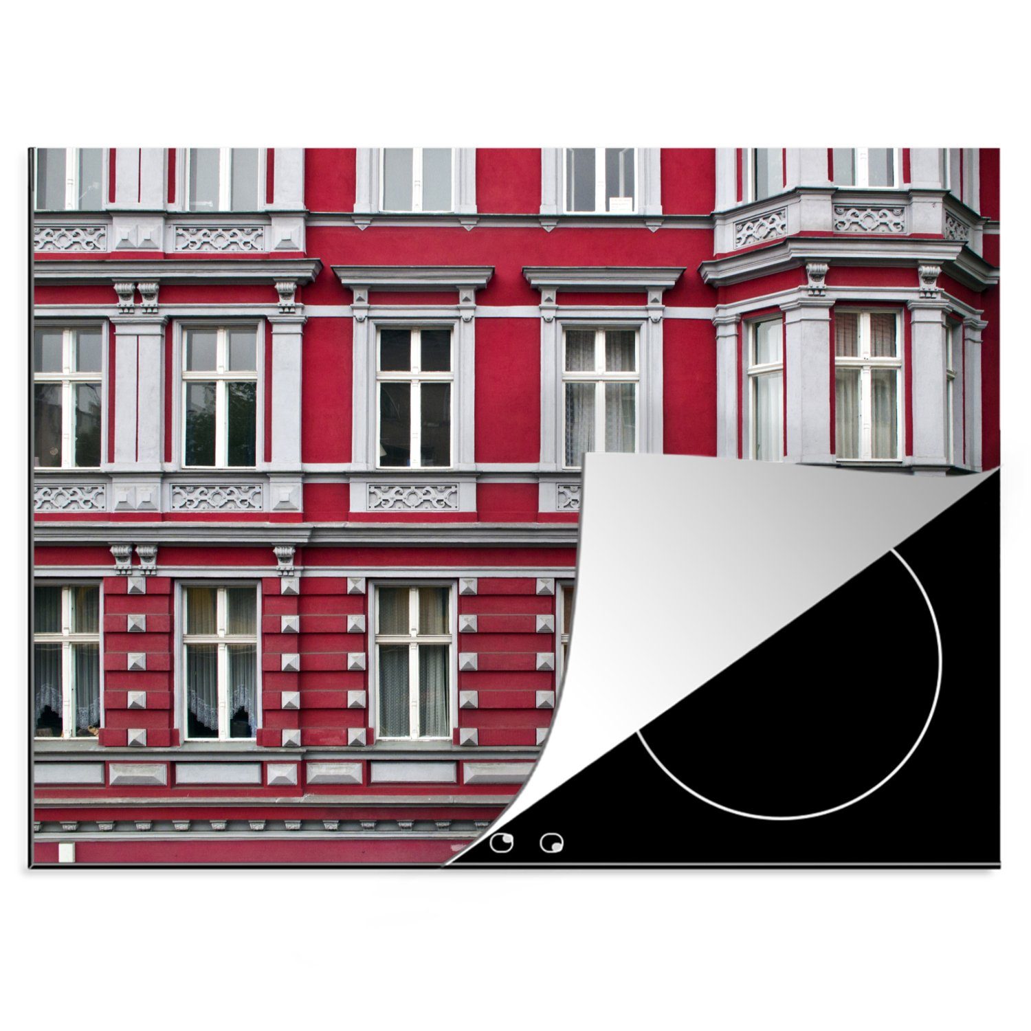 MuchoWow Herdblende-/Abdeckplatte Eine rote Fassade von Wohngebäuden in dem Viertel, Vinyl, (1 tlg), 70x52 cm, Mobile Arbeitsfläche nutzbar, Ceranfeldabdeckung