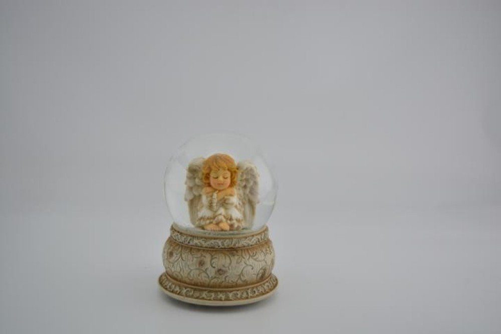 Musicboxworld Spieluhr Schneekugel 100 mm sitzender Engel