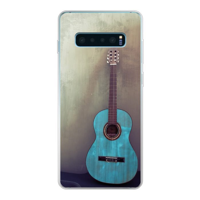 MuchoWow Handyhülle Farbige akustische Gitarre in einem Raum mit einer Betonwand Phone Case Handyhülle Samsung Galaxy S10 Lite Silikon Schutzhülle