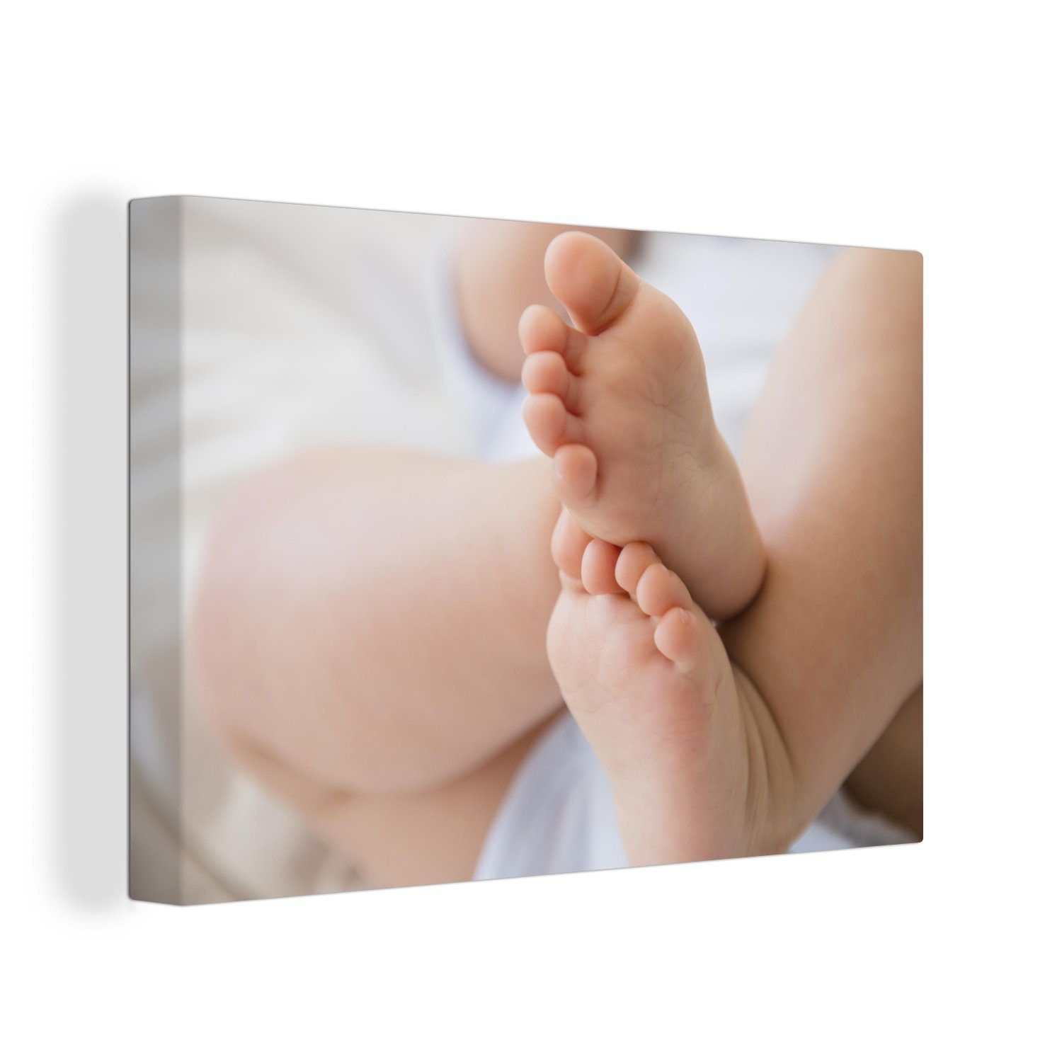 OneMillionCanvasses® Leinwandbild Die Füße eines Babys, (1 St), Wandbild Leinwandbilder, Aufhängefertig, Wanddeko, 30x20 cm