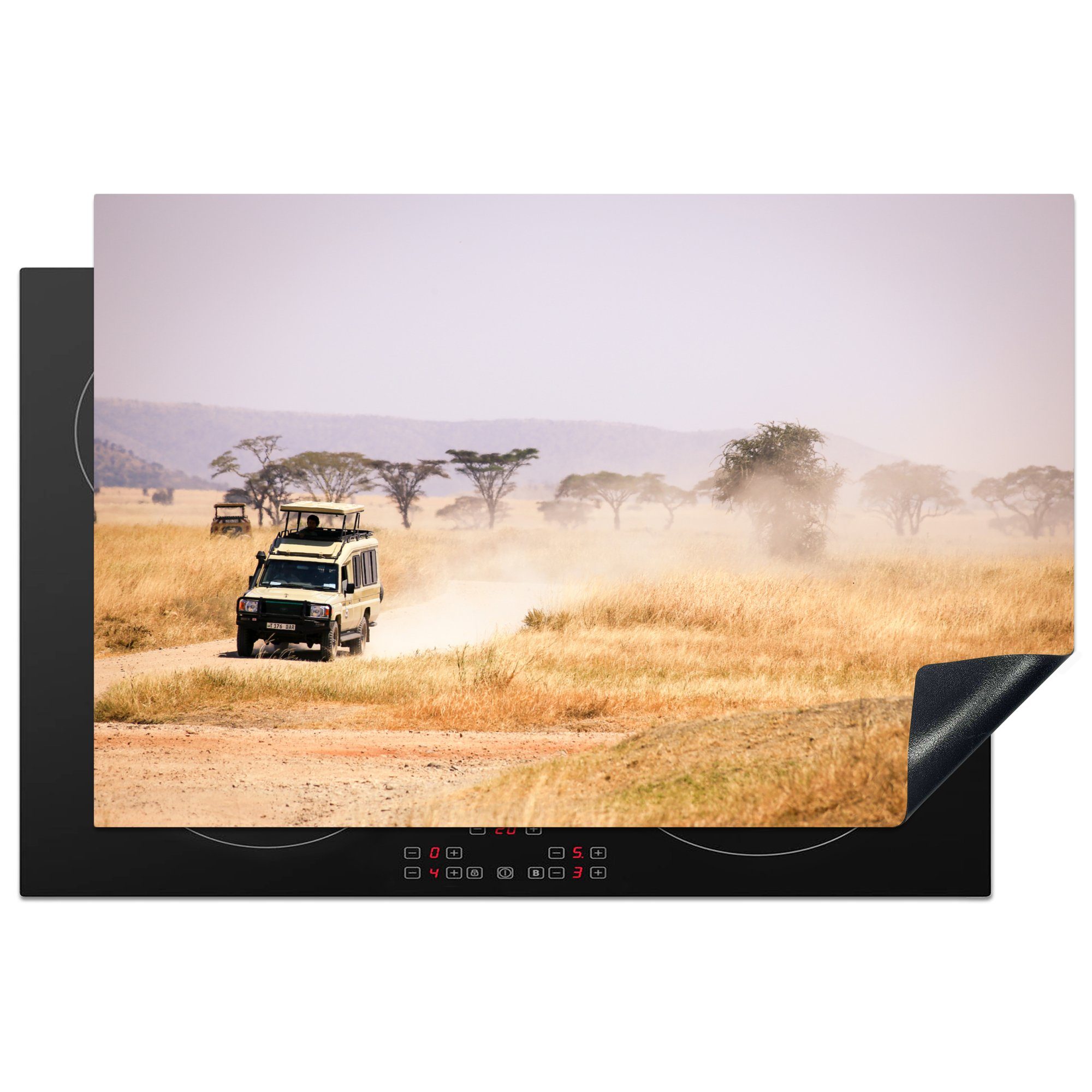 MuchoWow Herdblende-/Abdeckplatte Ein Safariauto fährt über das trockene Grasland in Afrika, Vinyl, (1 tlg), 81x52 cm, Induktionskochfeld Schutz für die küche, Ceranfeldabdeckung
