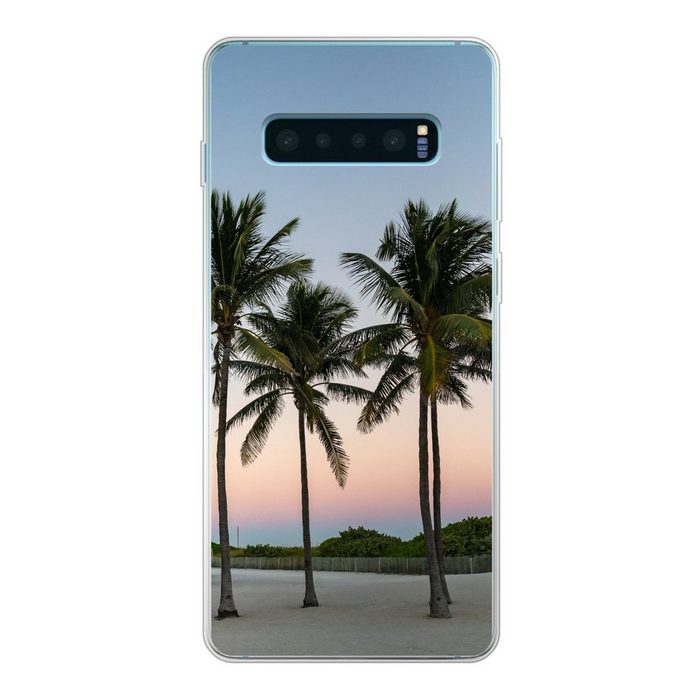 MuchoWow Handyhülle Eine Reihe von Palmen vor einem farbigen Himmel Phone Case Handyhülle Samsung Galaxy S10+ Silikon Schutzhülle