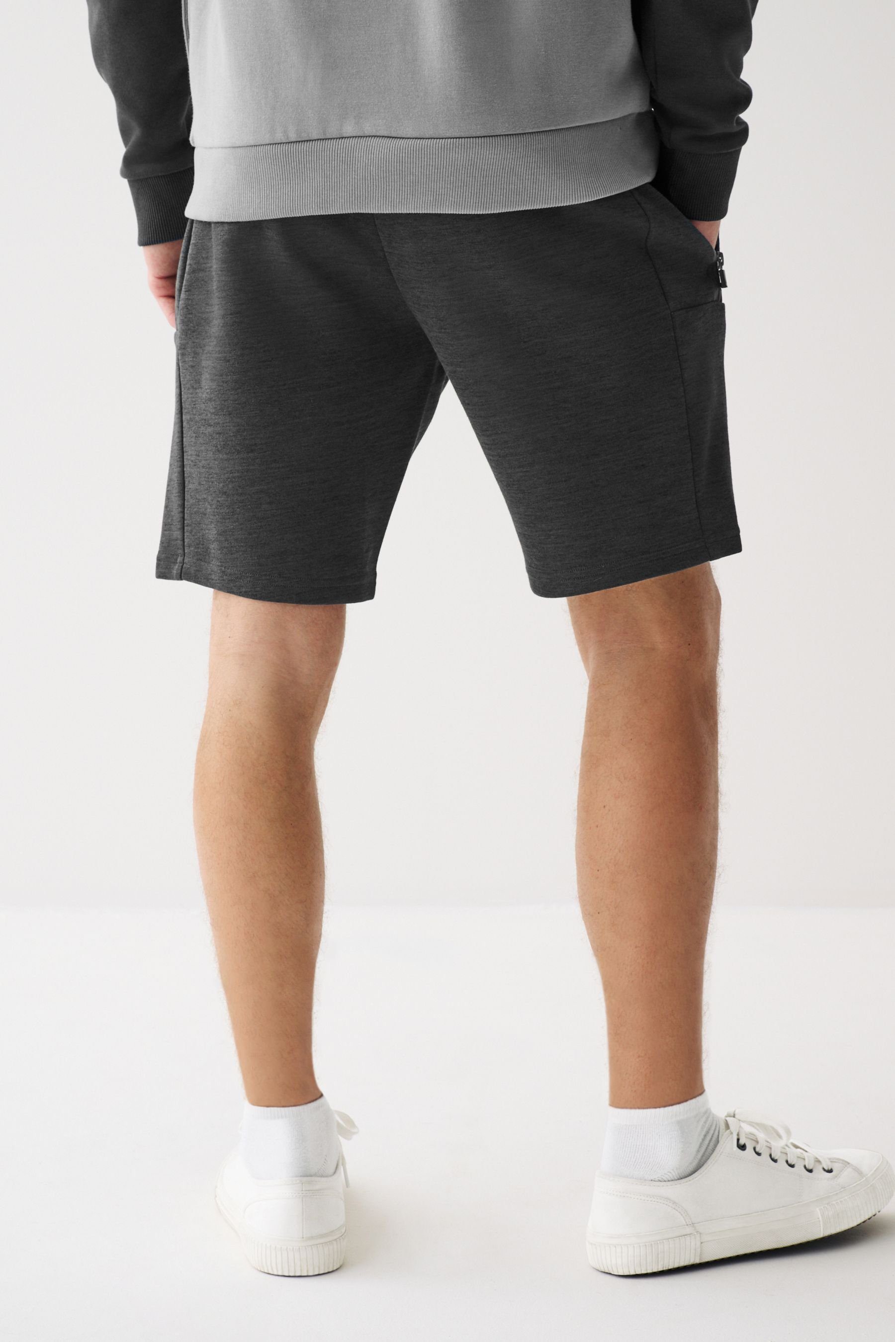 Jersey-Shorts Sweatshorts Grey Next mit Reißverschlusstaschen (1-tlg) Charcoal