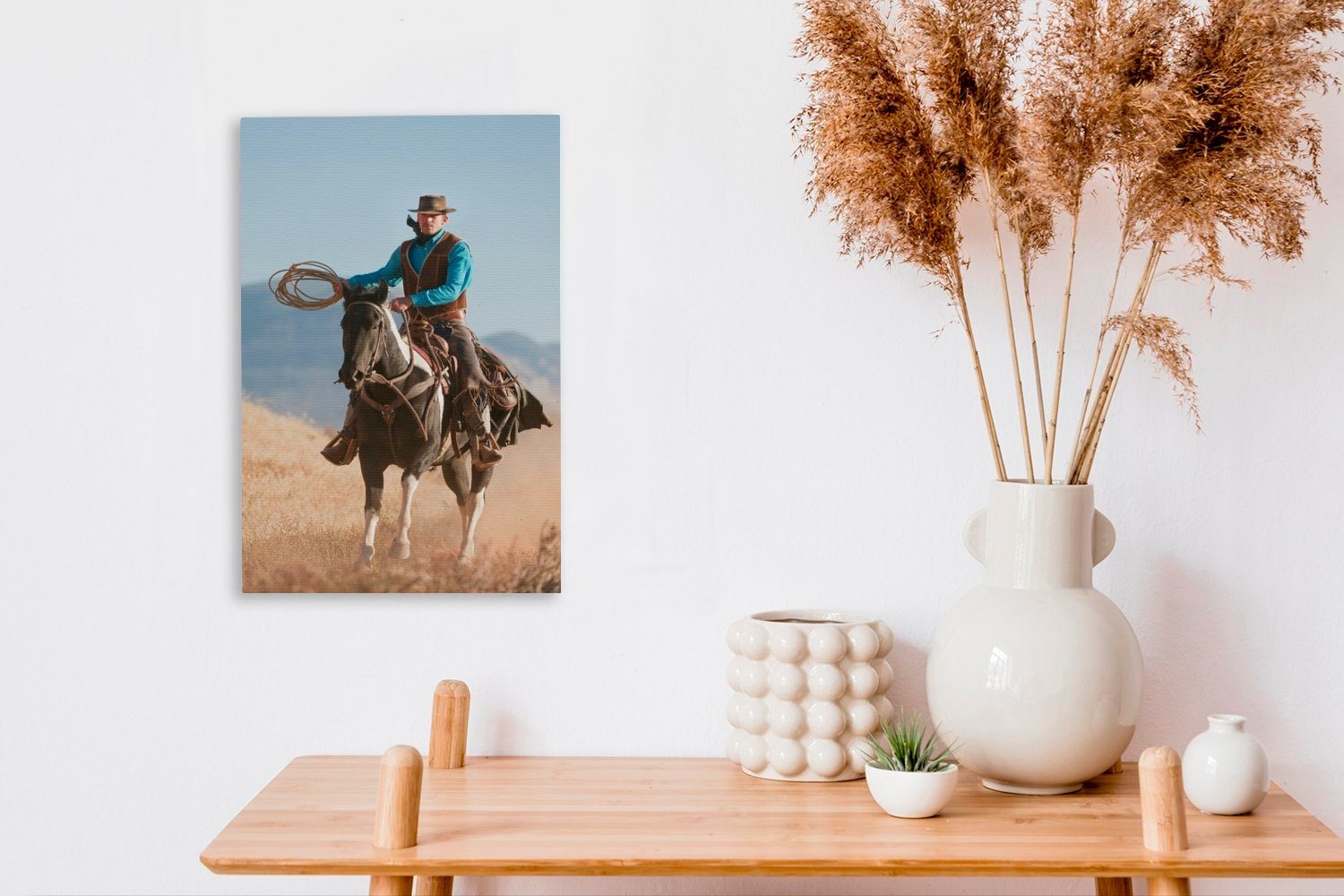 OneMillionCanvasses® Leinwandbild Ein Cowboy auf Gemälde, cm grauen bespannt inkl. (1 vor Himmel, Zackenaufhänger, Leinwandbild fertig St), Pferd einem 20x30 einem