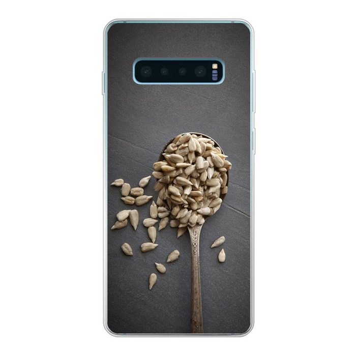 MuchoWow Handyhülle Weiße Sonnenblumenkerne auf einer grauen Oberfläche Phone Case Handyhülle Samsung Galaxy S10+ Silikon Schutzhülle