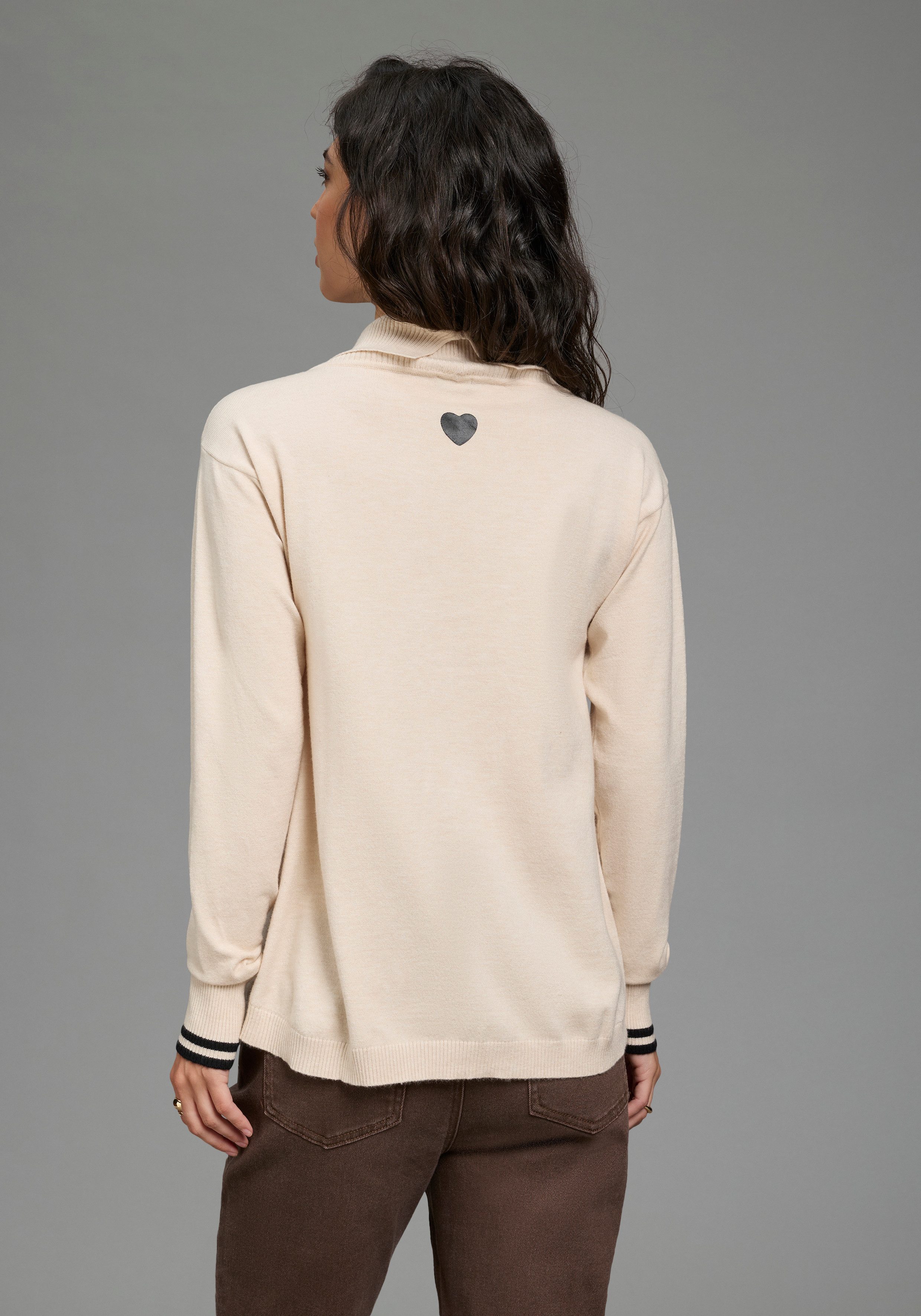 Laura Scott Strickpullover aus Feinstrick, hüftlange Schnittform mit Rollkragen und Kontraststreifen. € 39,99