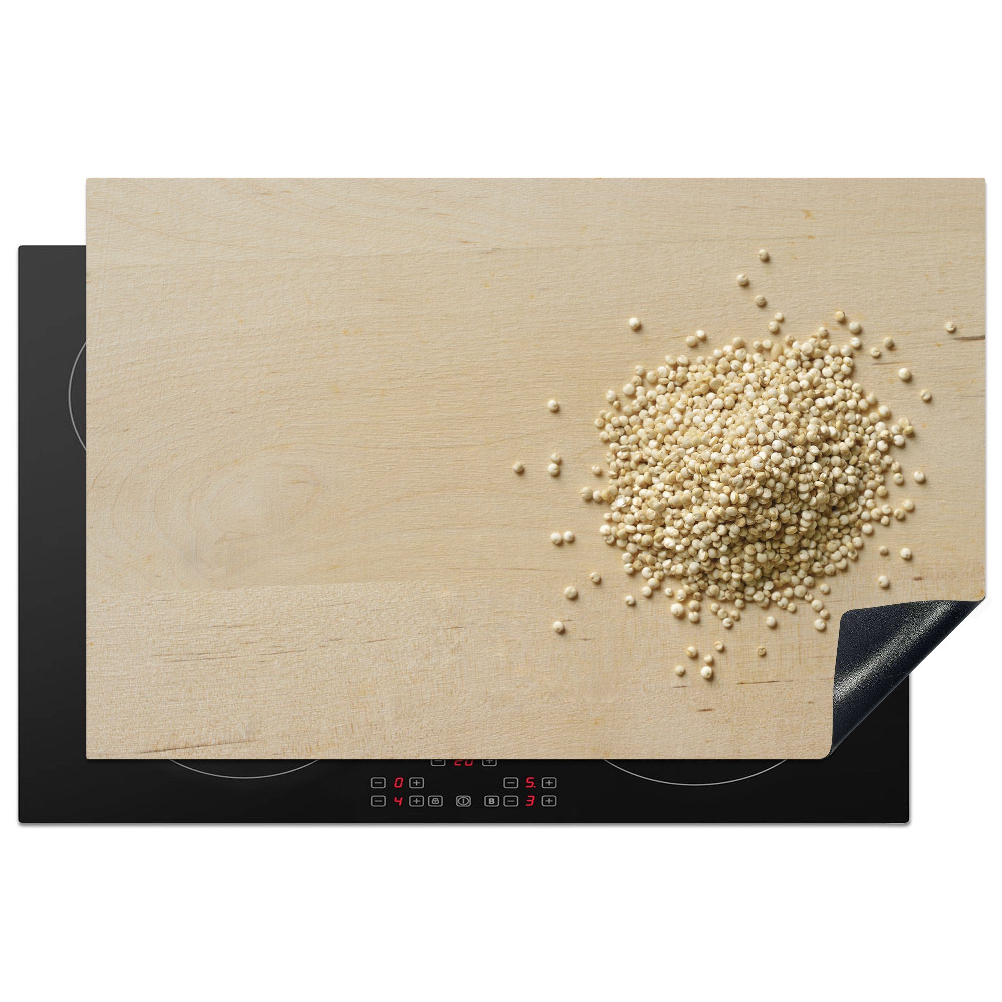 MuchoWow Herdblende-/Abdeckplatte Ein Haufen Quinoa auf einem hölzernen Schneidebrett, Vinyl, (1 tlg), 81x52 cm, Induktionskochfeld Schutz für die küche, Ceranfeldabdeckung