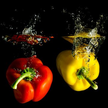 Wallario Möbelfolie Bunte Küche Paprika in rot gelb orange und grün im Wasser