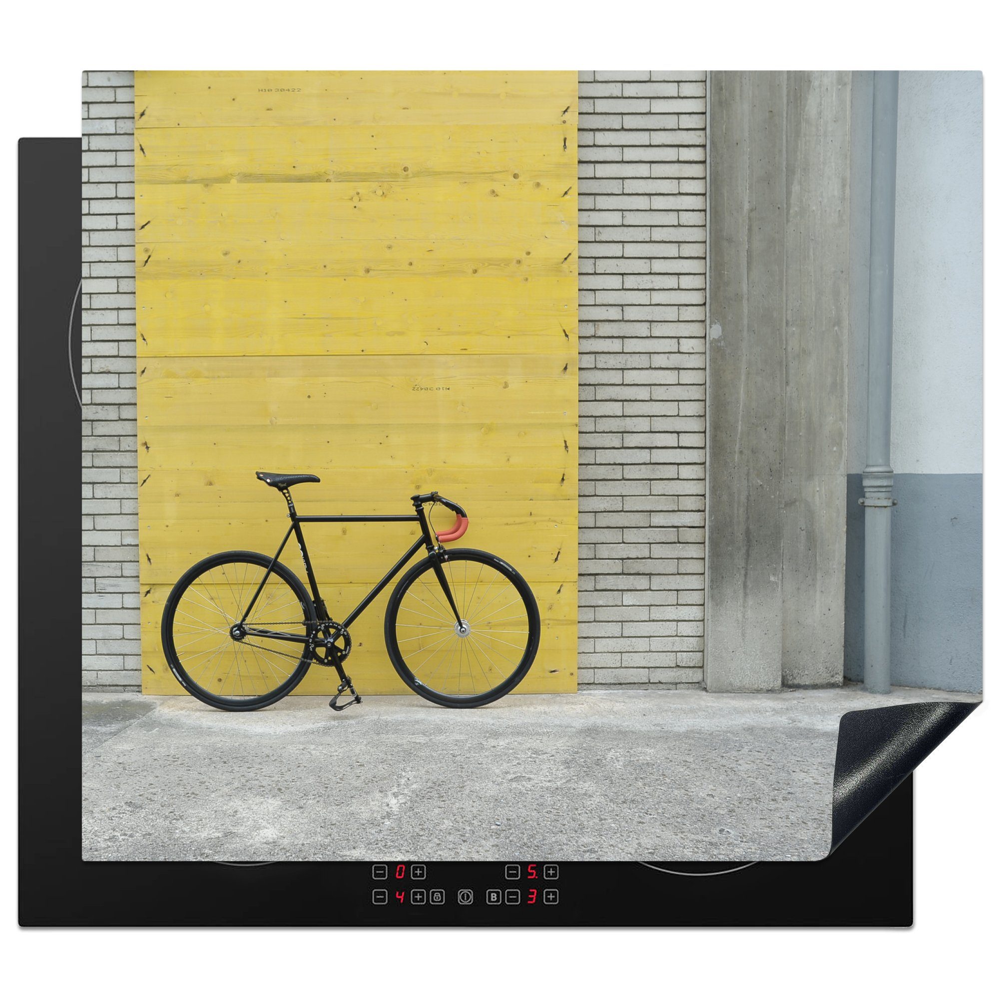 MuchoWow Herdblende-/Abdeckplatte Ein Rennrad vor einem industriellen Hintergrund, Vinyl, (1 tlg), 59x52 cm, Ceranfeldabdeckung für die küche, Induktionsmatte