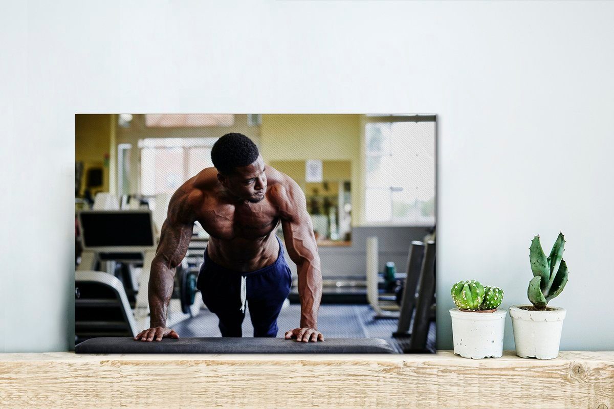 OneMillionCanvasses® Leinwandbild Ein Bodybuilder beim Aufhängefertig, 30x20 Training cm Wandbild Wanddeko, Fitnessstudio, (1 St), im Leinwandbilder