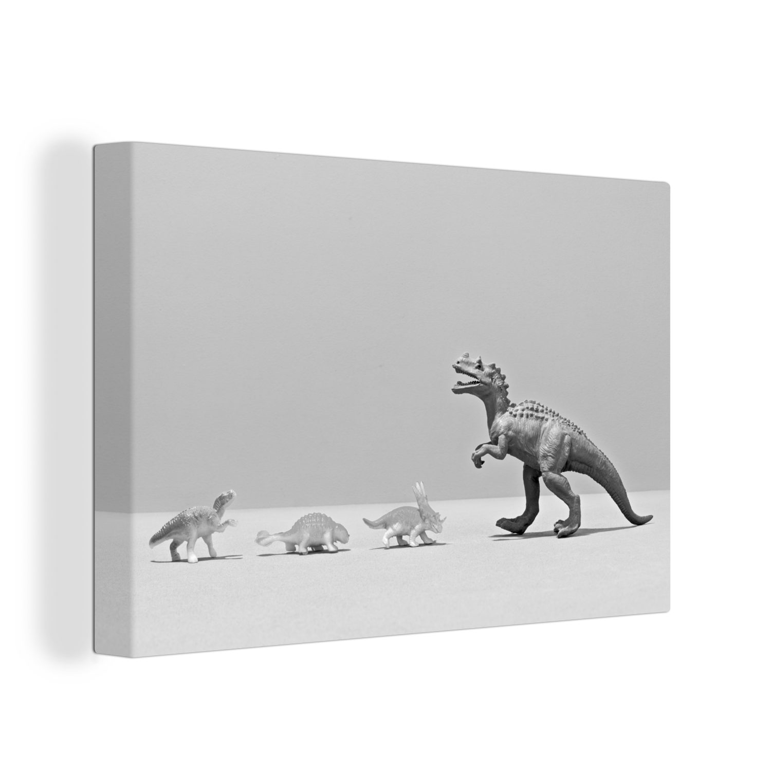 OneMillionCanvasses® Leinwandbild Kleine Spielzeugdinosaurier treffen auf einen großen Dino - schwarz, (1 St), Wandbild Leinwandbilder, Aufhängefertig, Wanddeko, 30x20 cm