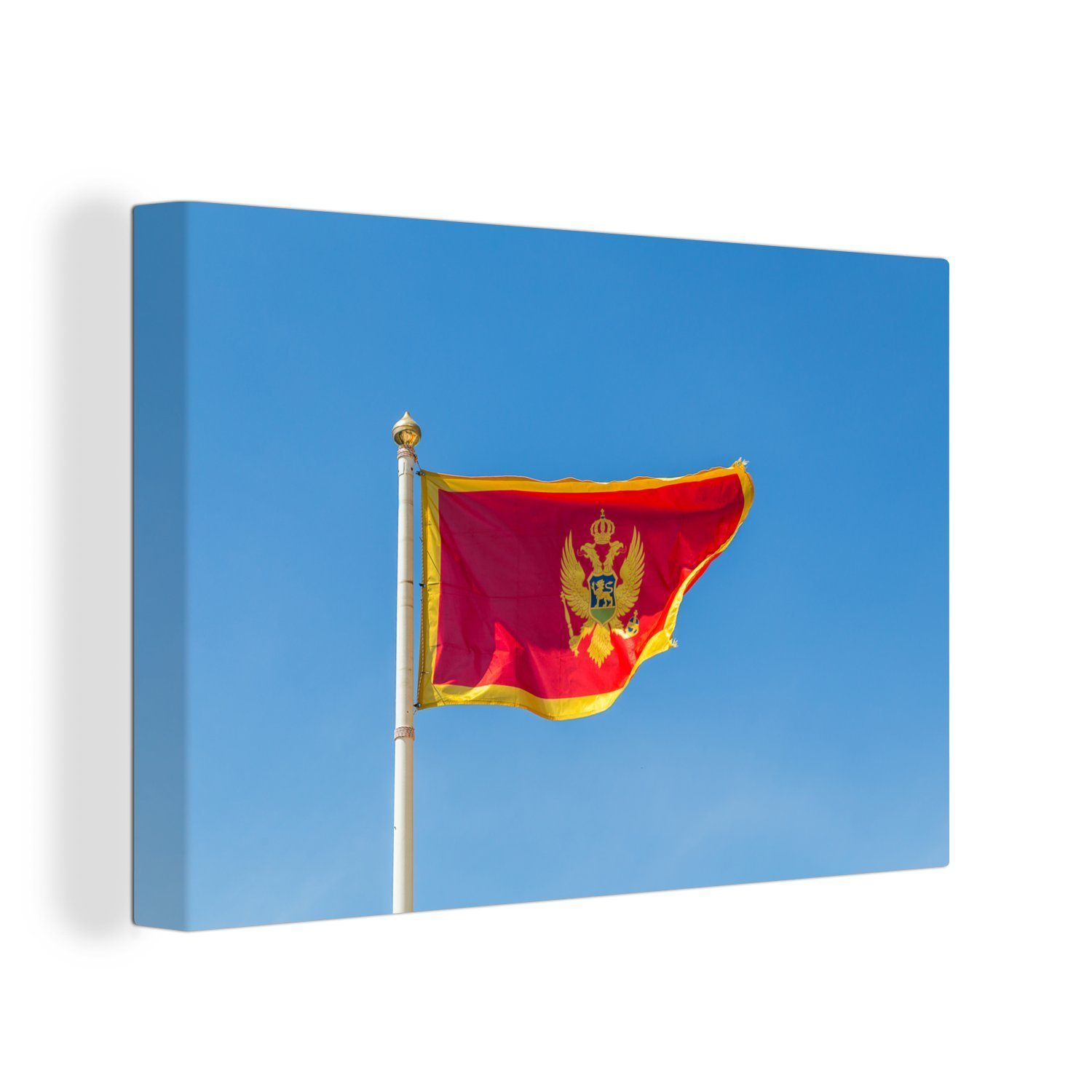 OneMillionCanvasses® Leinwandbild Flagge von Montenegro vor einem klaren blauen Himmel, (1 St), Wandbild Leinwandbilder, Aufhängefertig, Wanddeko, 30x20 cm