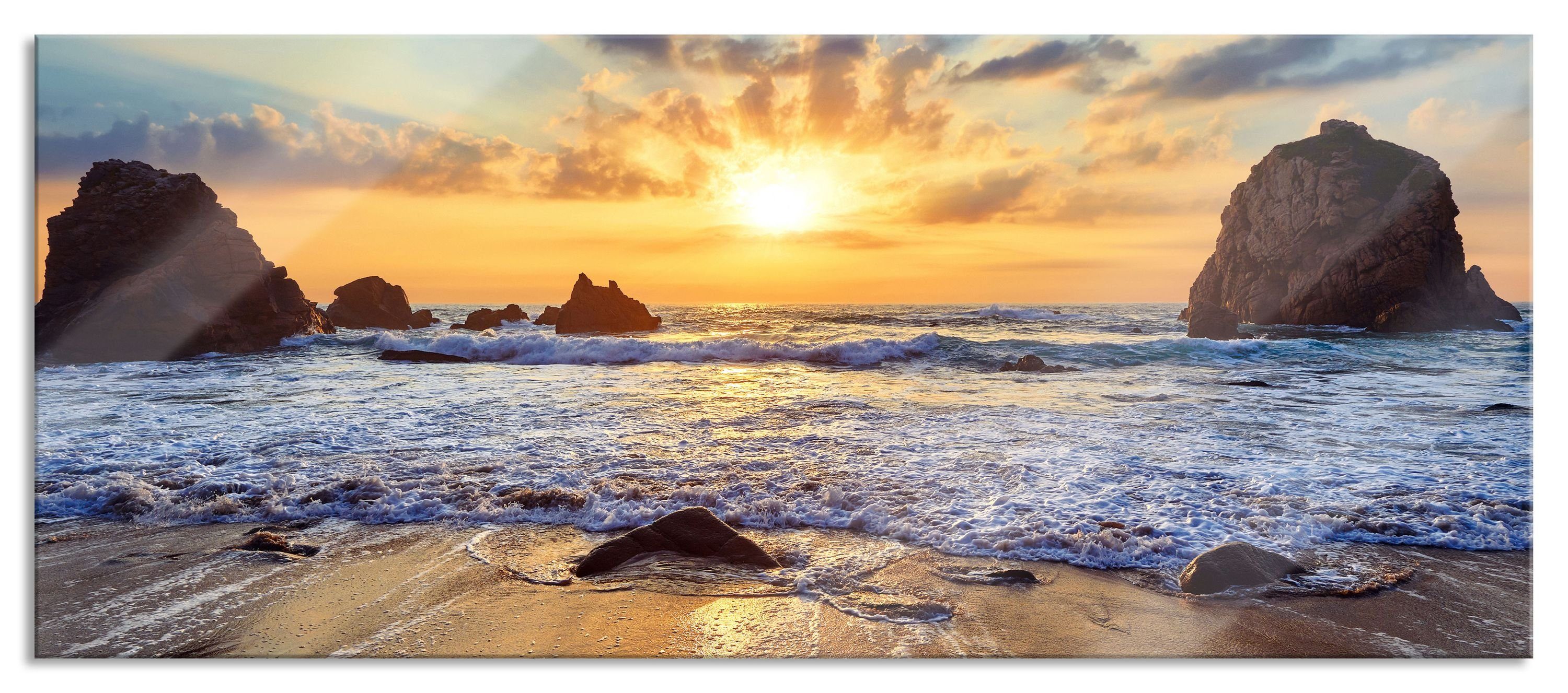 Glasbild Sandstrand mit Felsen im Sonnenuntergang