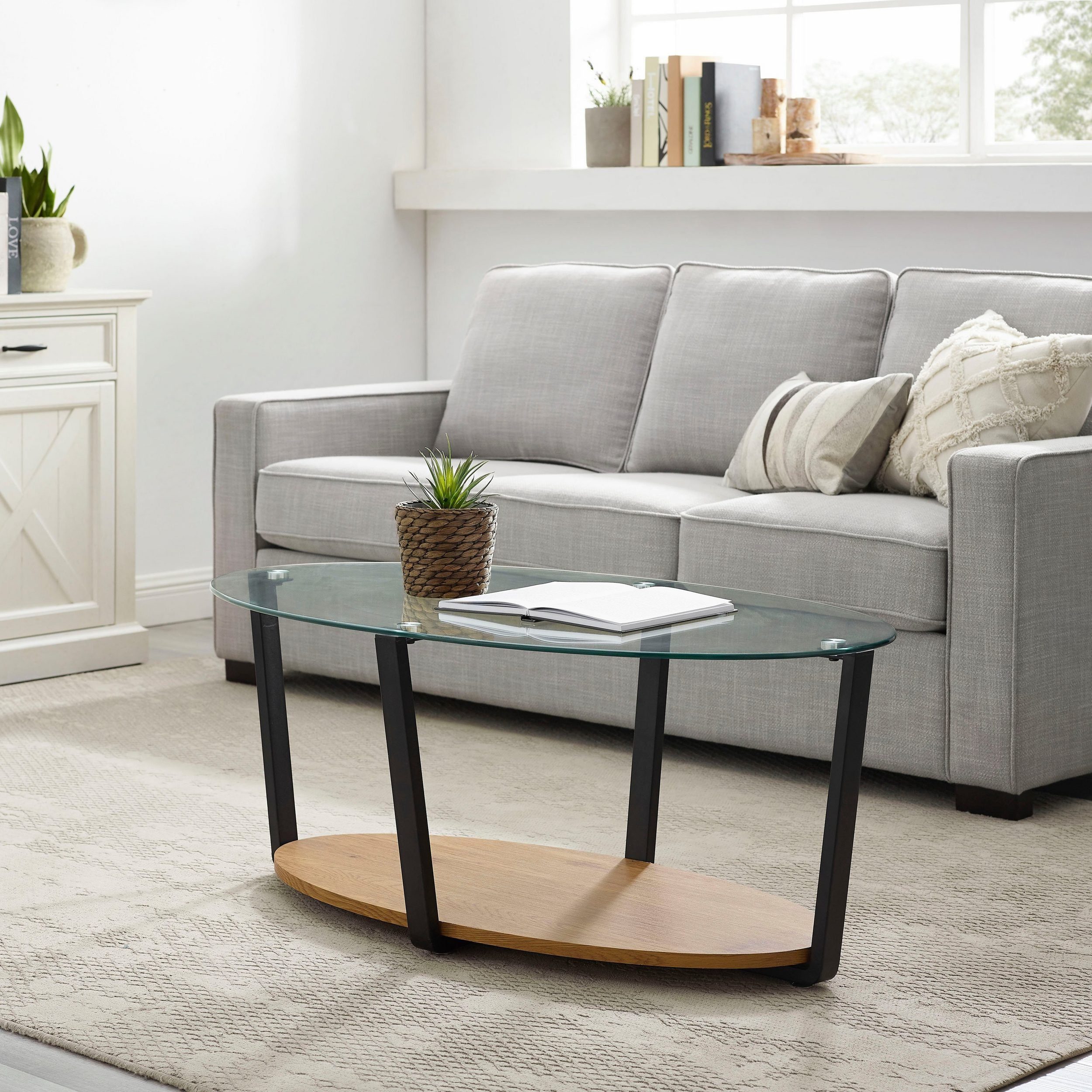 loft24 Couchtisch Blaine, Wohnzimmertisch oval mit Tischplatte aus Glas, Breite 110 cm