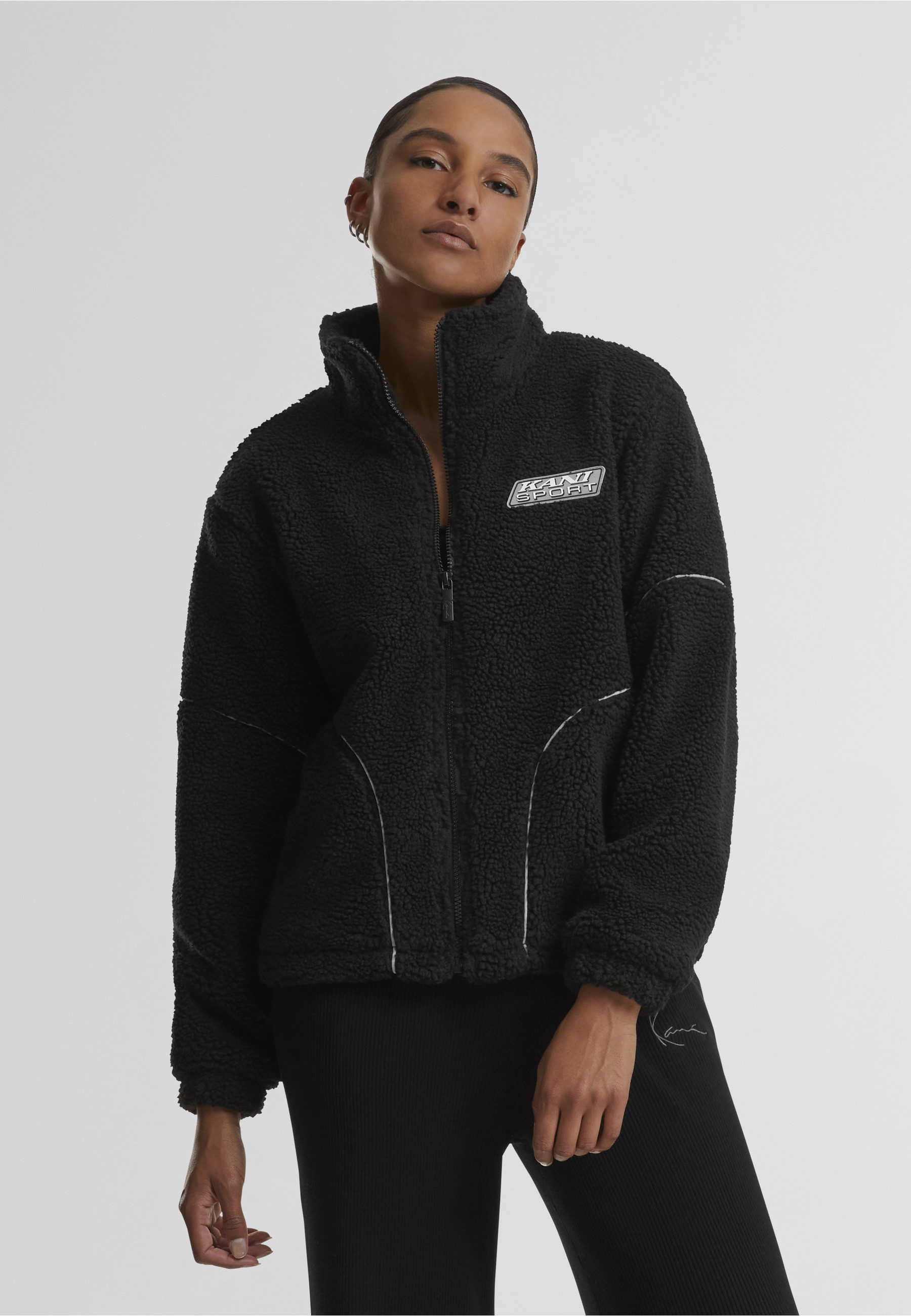 Karl Kani Trainingsjacke Karl Kani Karl Kani Sport Patch Teddy Block Trackjacket (1-St)