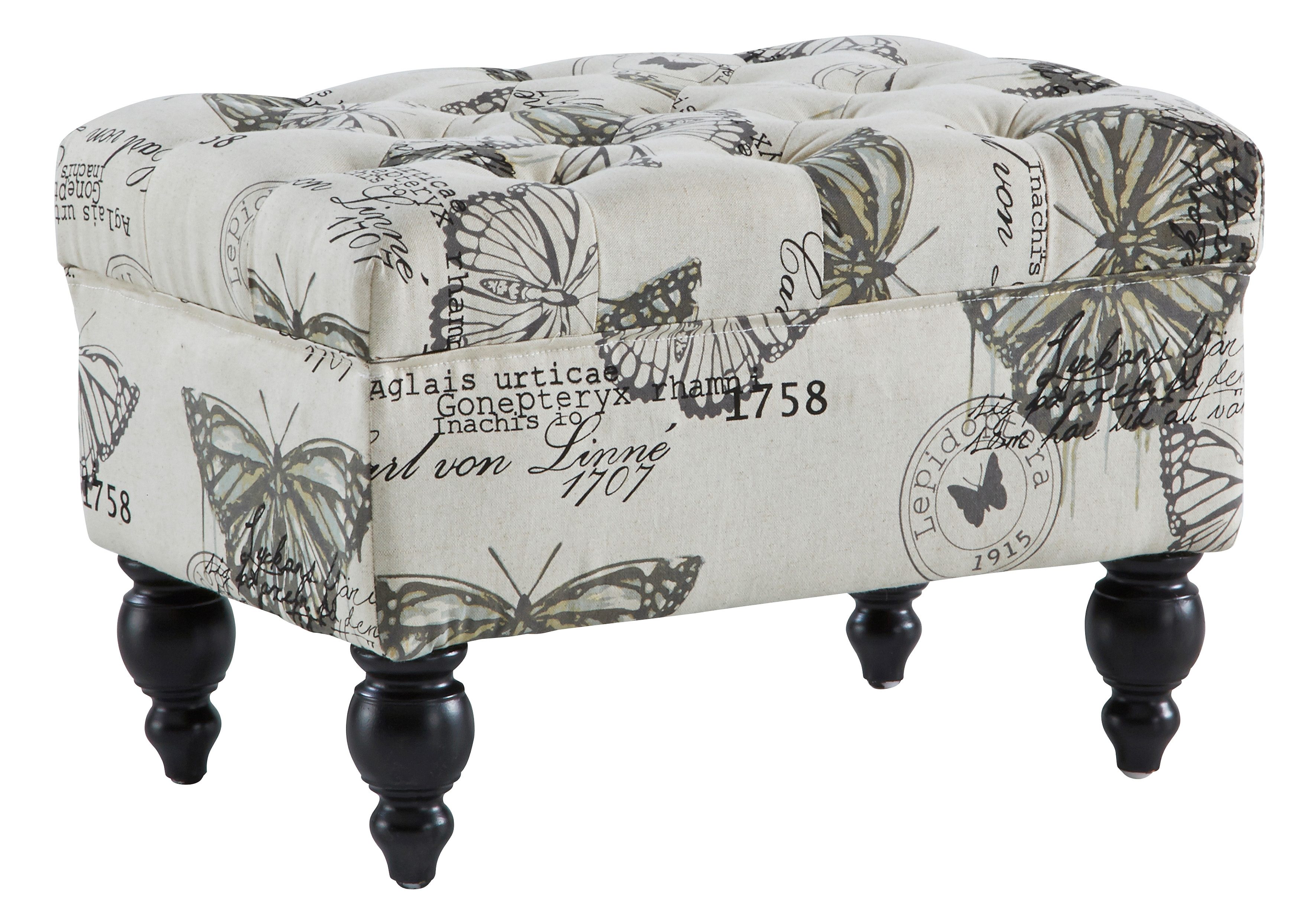 picture of a stool with black, baroque wooden feet and a pale fabric with printed black and gray butterflies