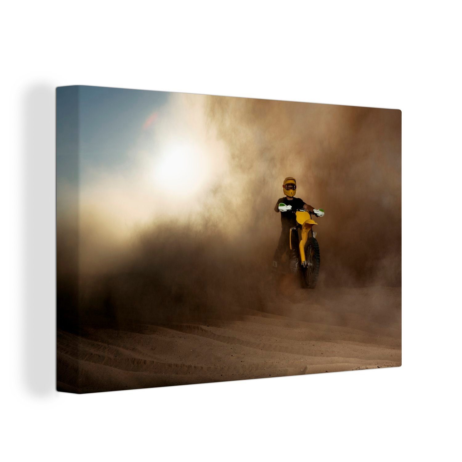 OneMillionCanvasses® Leinwandbild Ein Aufhängefertig, 30x20 Wanddeko, gelben Mann einer Staubwolke, cm auf Wandbild einem (1 Leinwandbilder, Motorrad in St)