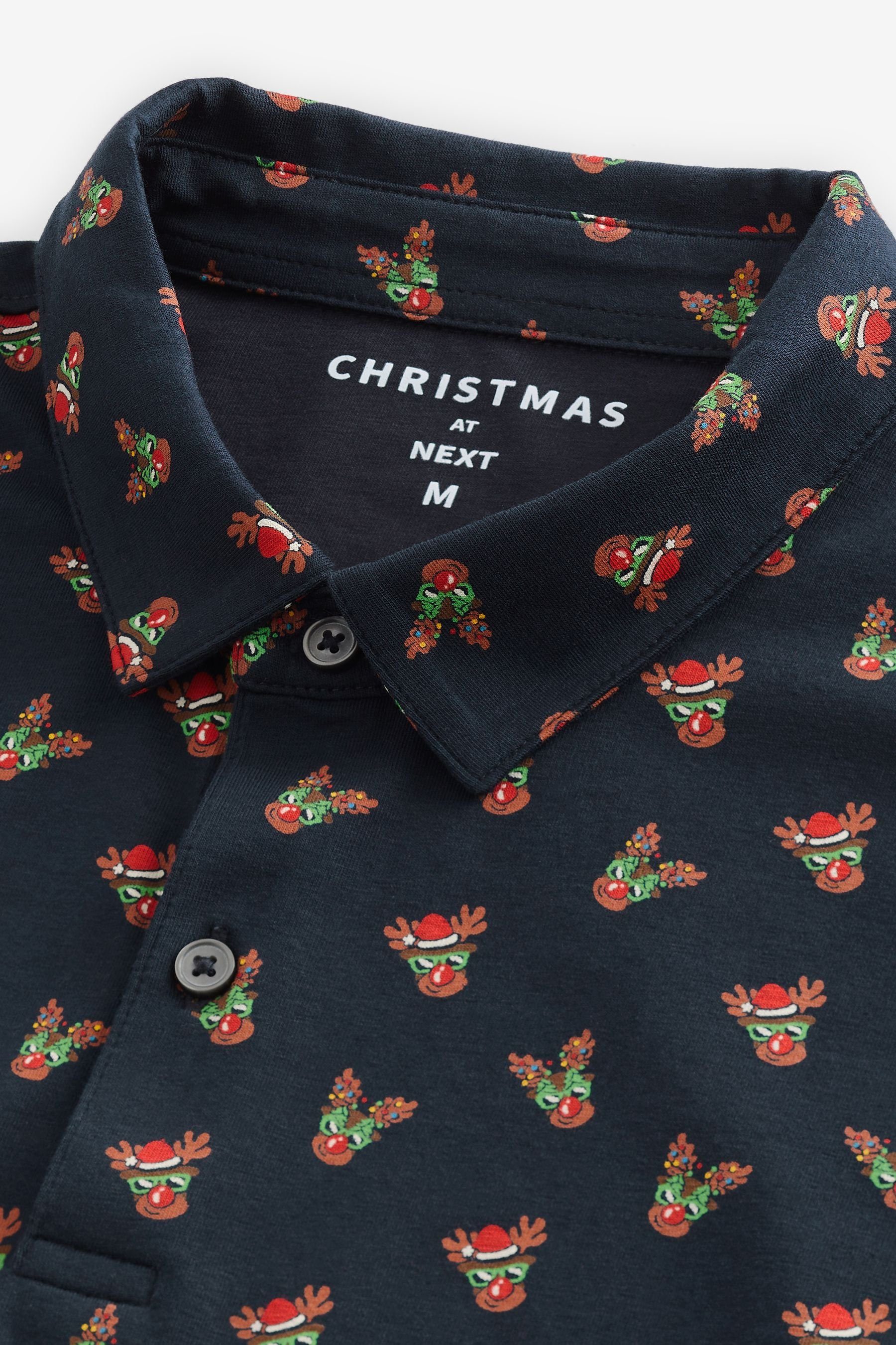 Poloshirt Navy weihnachtlichem in Blue Polo-Shirt (1-tlg) Next Print Reindeer