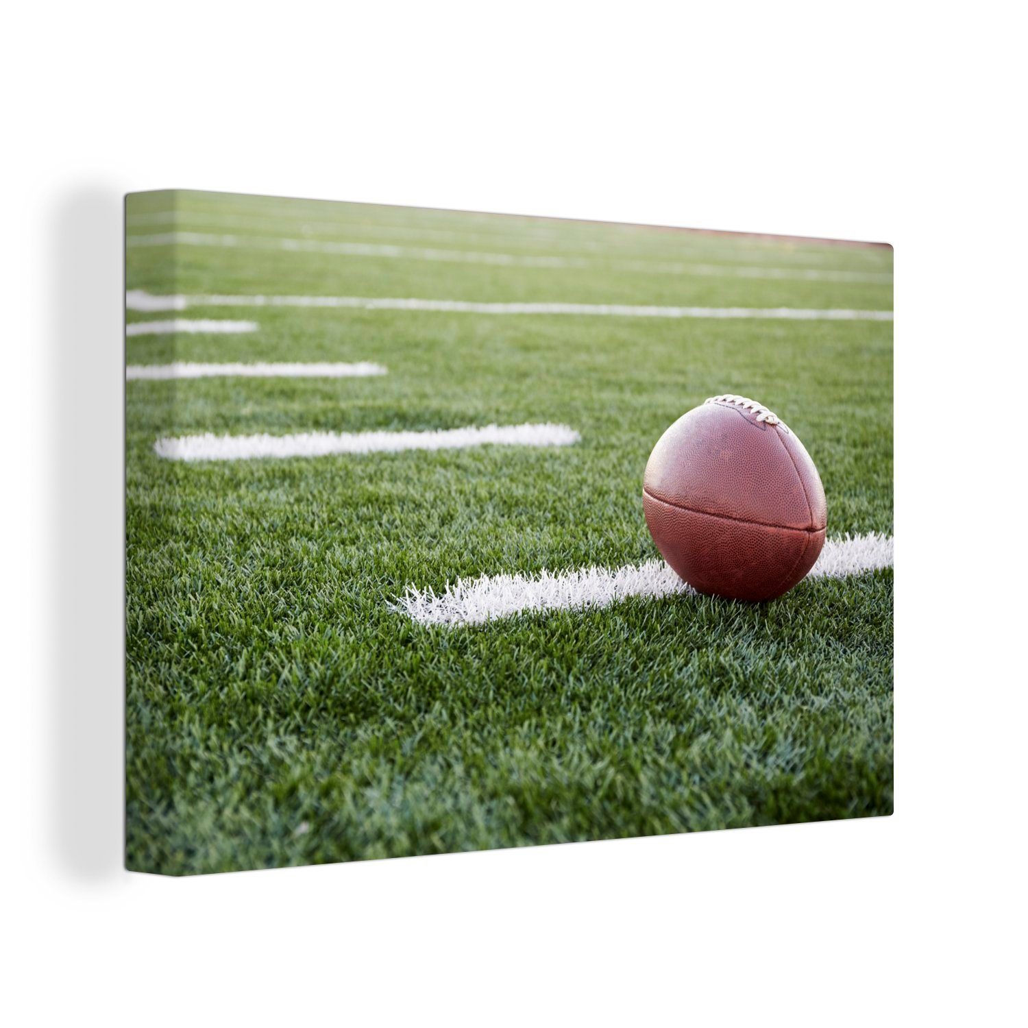 OneMillionCanvasses® Leinwandbild Nahaufnahme eines American Football auf einem schönen Feld, (1 St), Wandbild Leinwandbilder, Aufhängefertig, Wanddeko, 30x20 cm