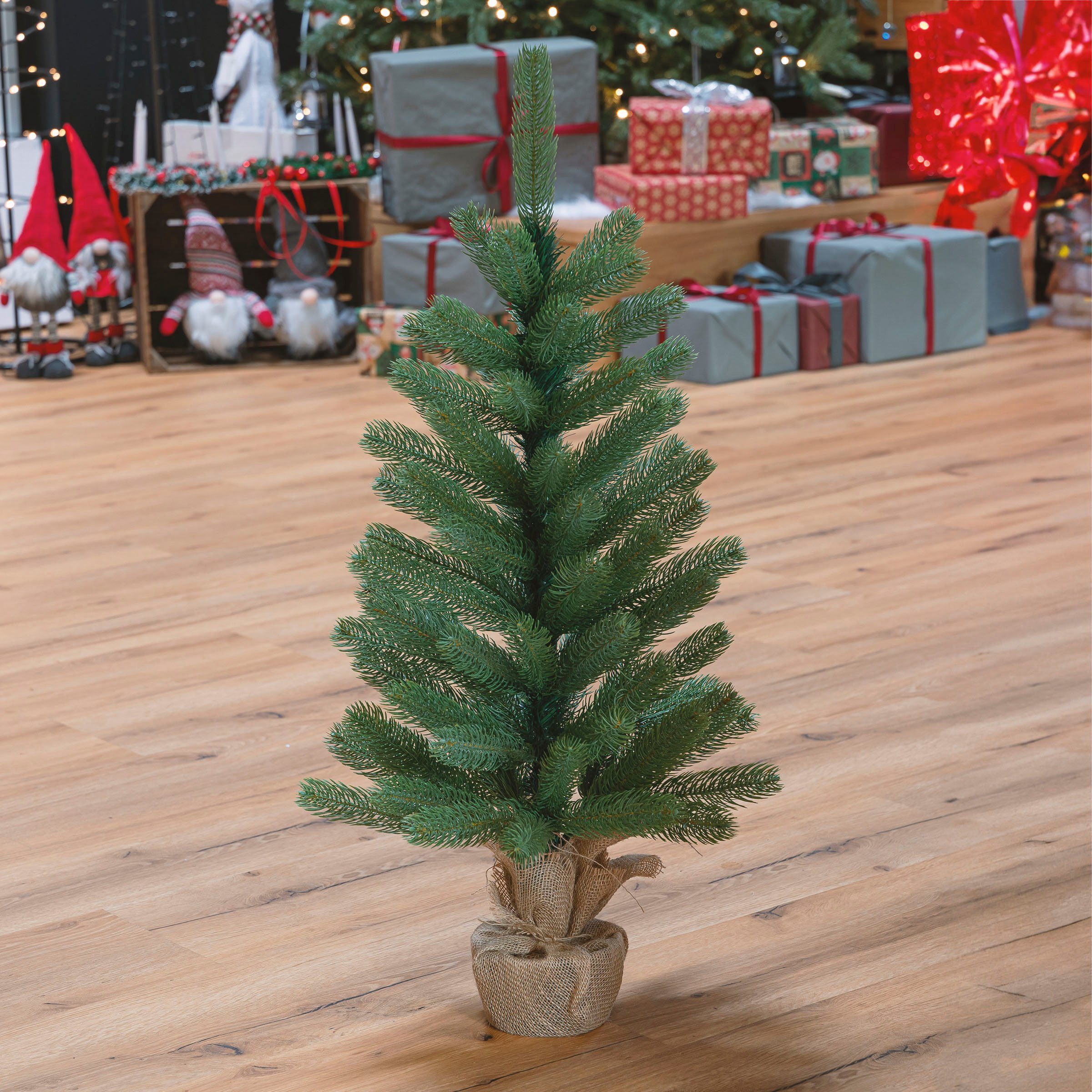 IC Winterworld Künstlicher Weihnachtsbaum Tannenbaum, künstlicher Christbaum, Nordmanntanne, Weihnachtsdeko mit Jutebeutel um den Betonfuß