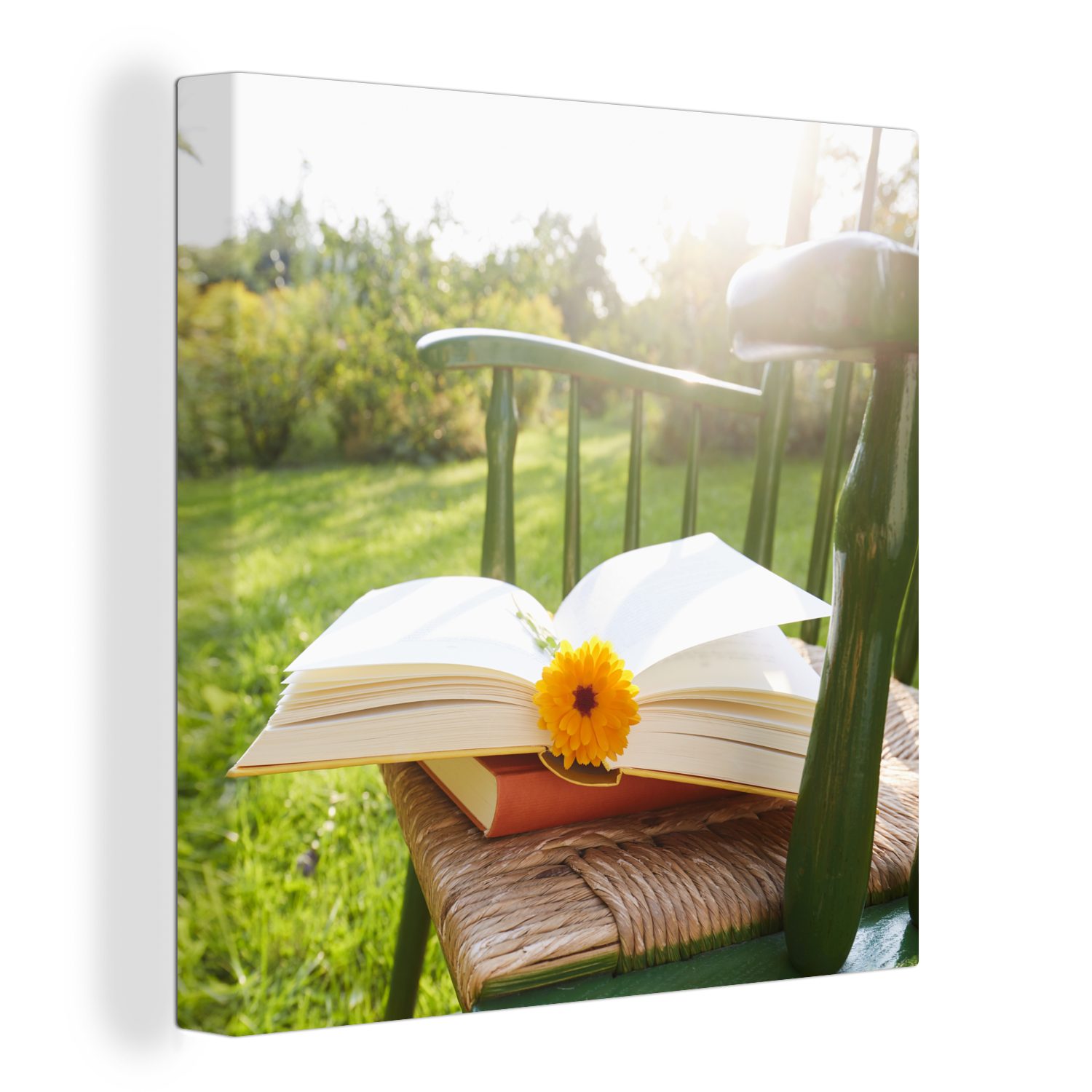 OneMillionCanvasses® Leinwandbild Stuhl mit Buch im Garten, (1 St